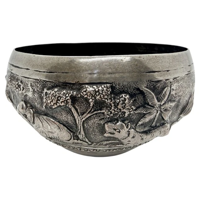 A small antique Indian silver bowl, decorated with an emboss...