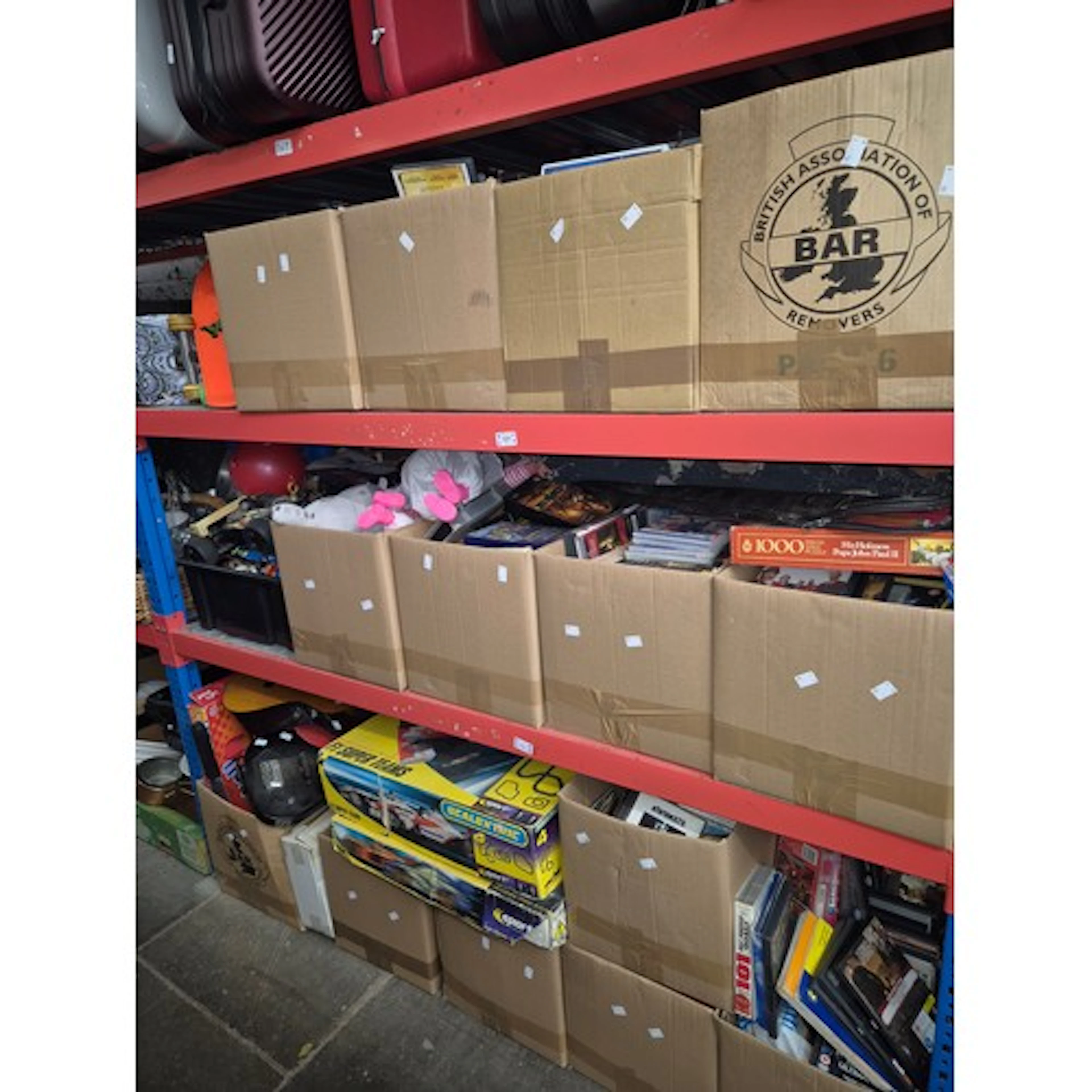 3 shelves (16 boxes) to include DVDs, videos, dolls, guitars...