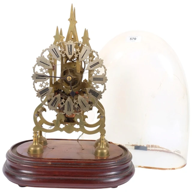 A brass skeleton clock on wooden plinth, under glass dome A/...