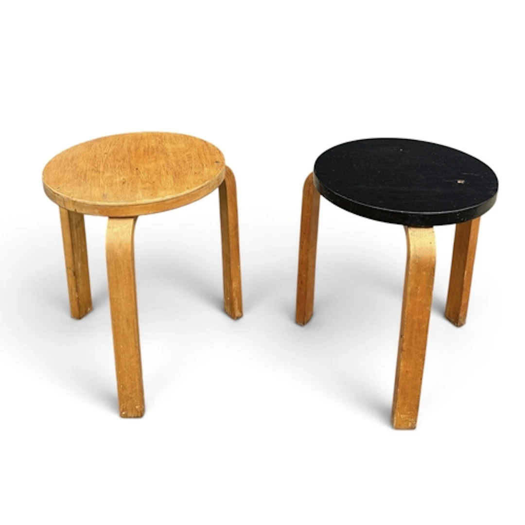 A PAIR OF ALVAR AALTO MODEL SIXTY STOOLS One with painted to...