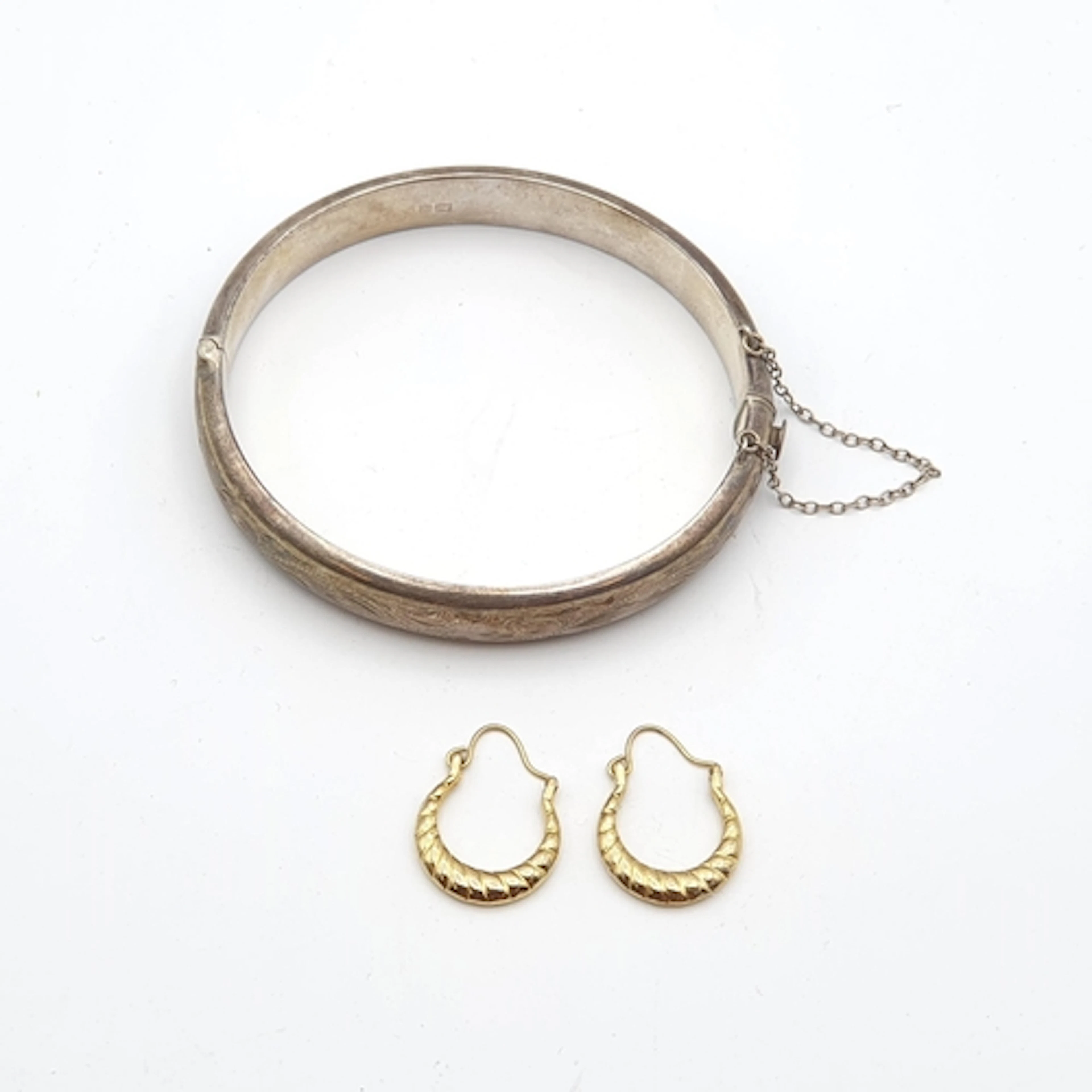 A vintage engraved Silver Bangle with safety chain, Birmingh...
