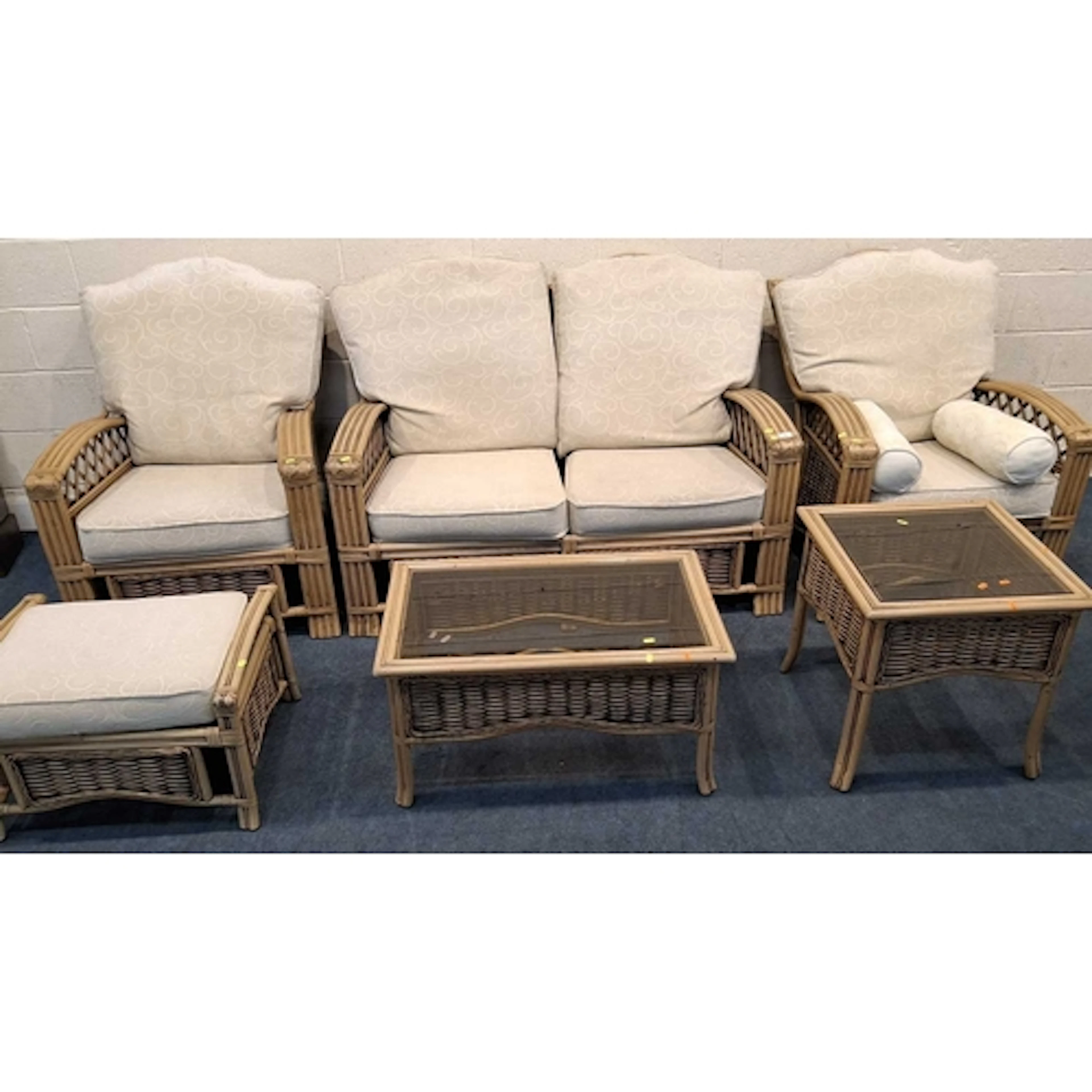 A RATTAN SIX PIECE CONSERVATORY SUITE, comprising a two-seat...
