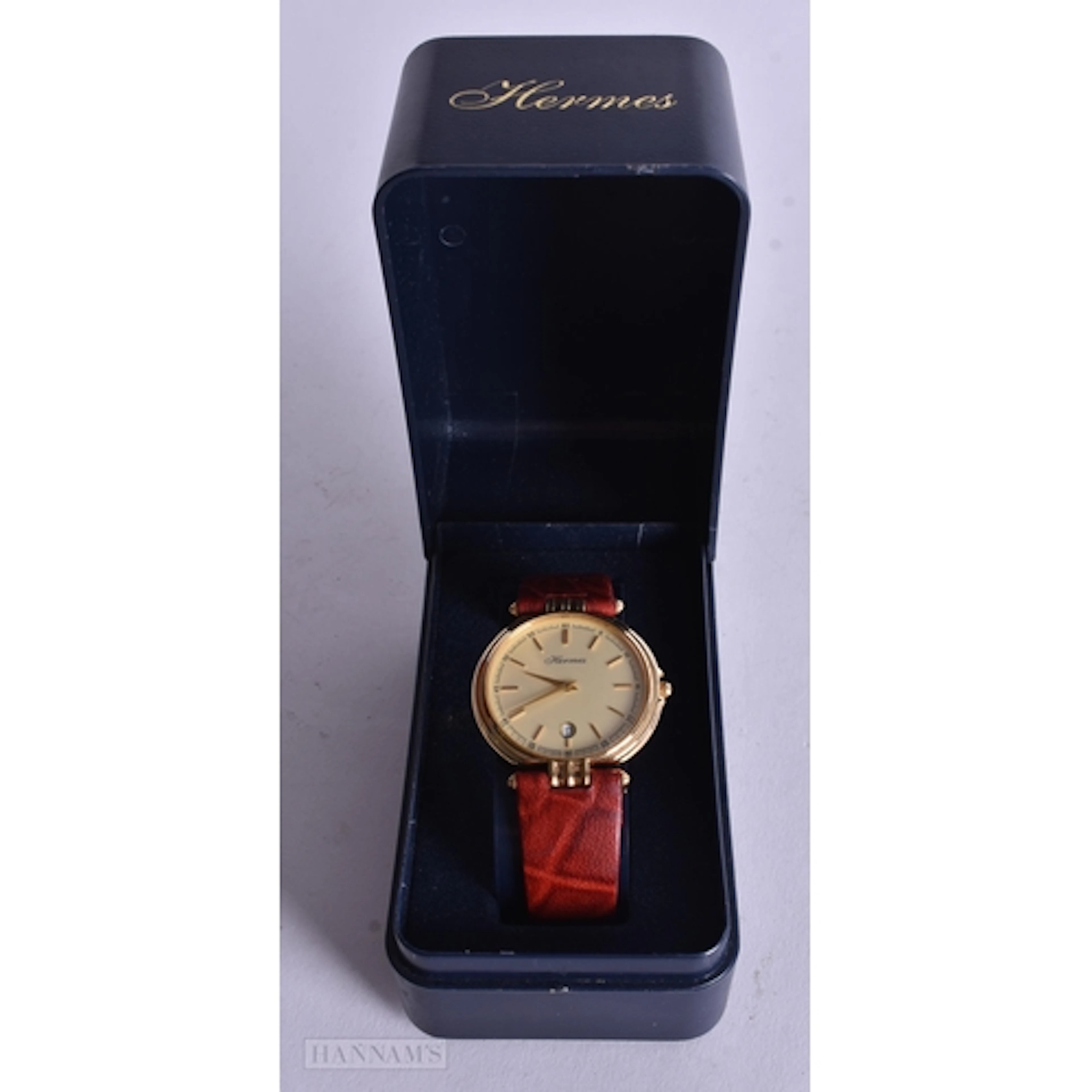 A Boxed Vintage Hermes Watch with a Gold Dial and Red Textur...