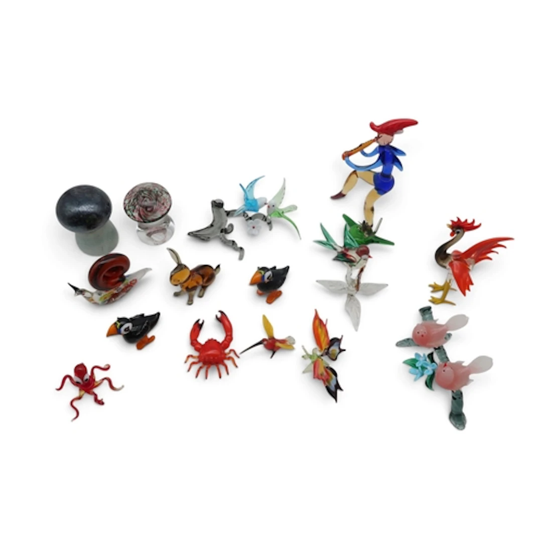 A group of lamp work animals, birds, a pied piper figure and...