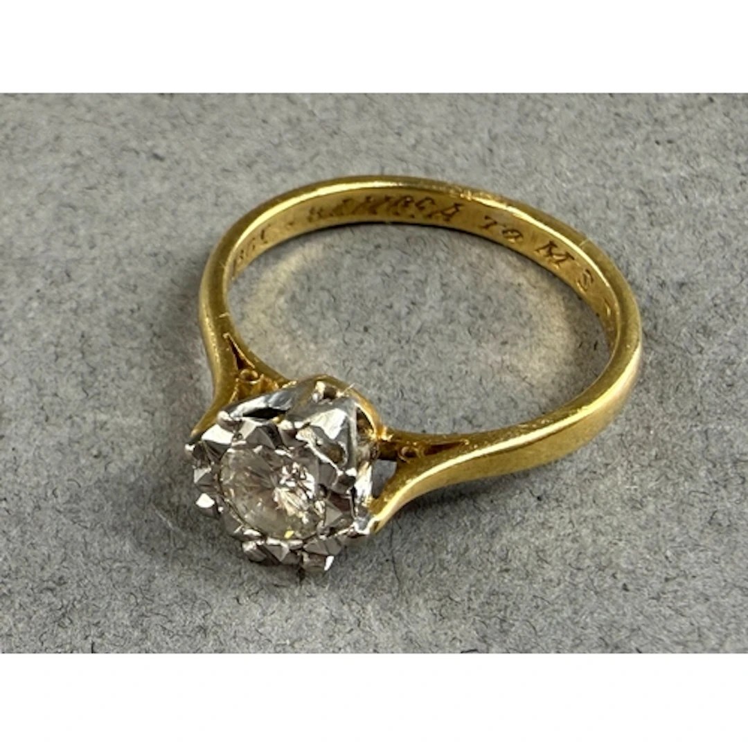 Jewellery: a yellow metal and diamond solitaire ring, marked...