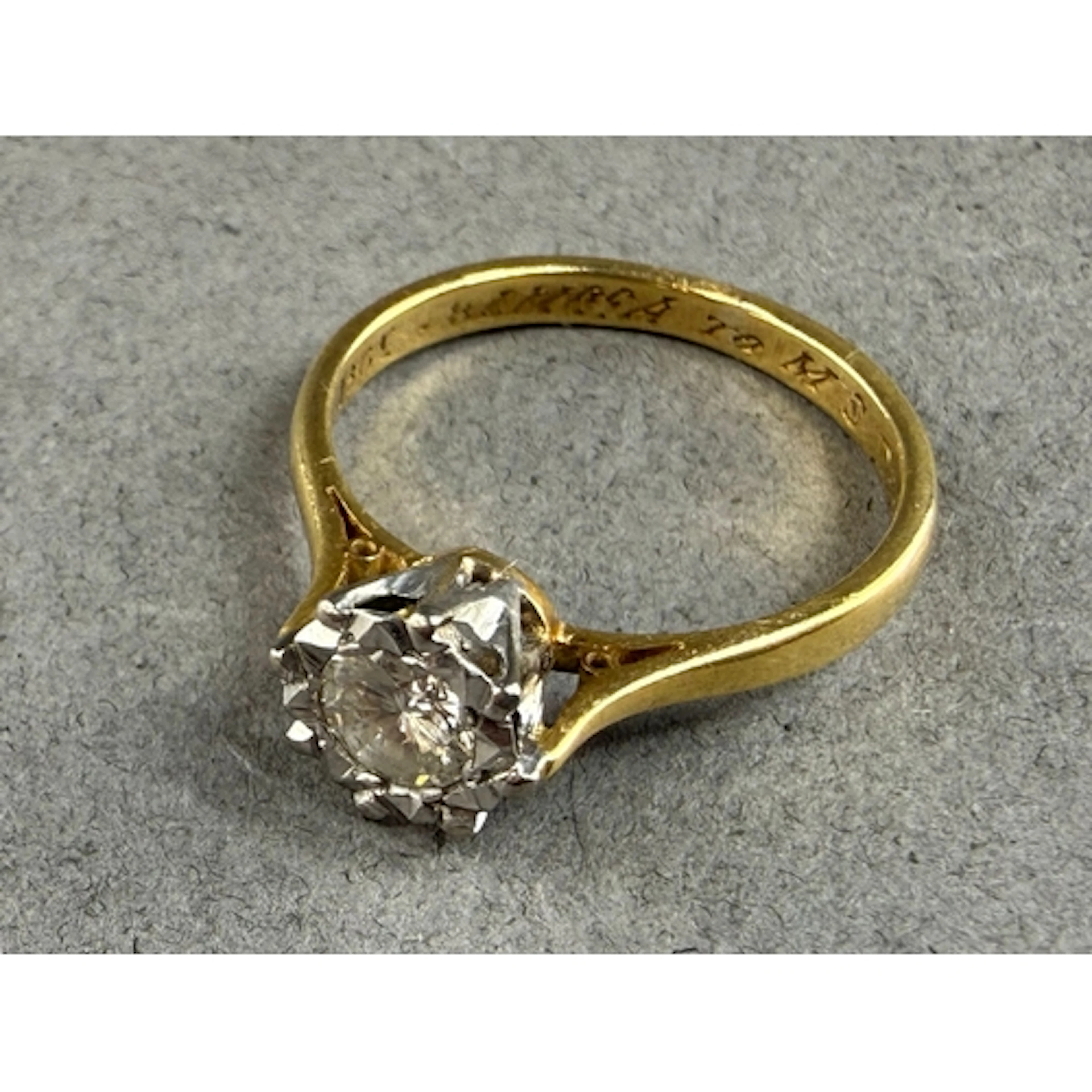 Jewellery: a yellow metal and diamond solitaire ring, marked...