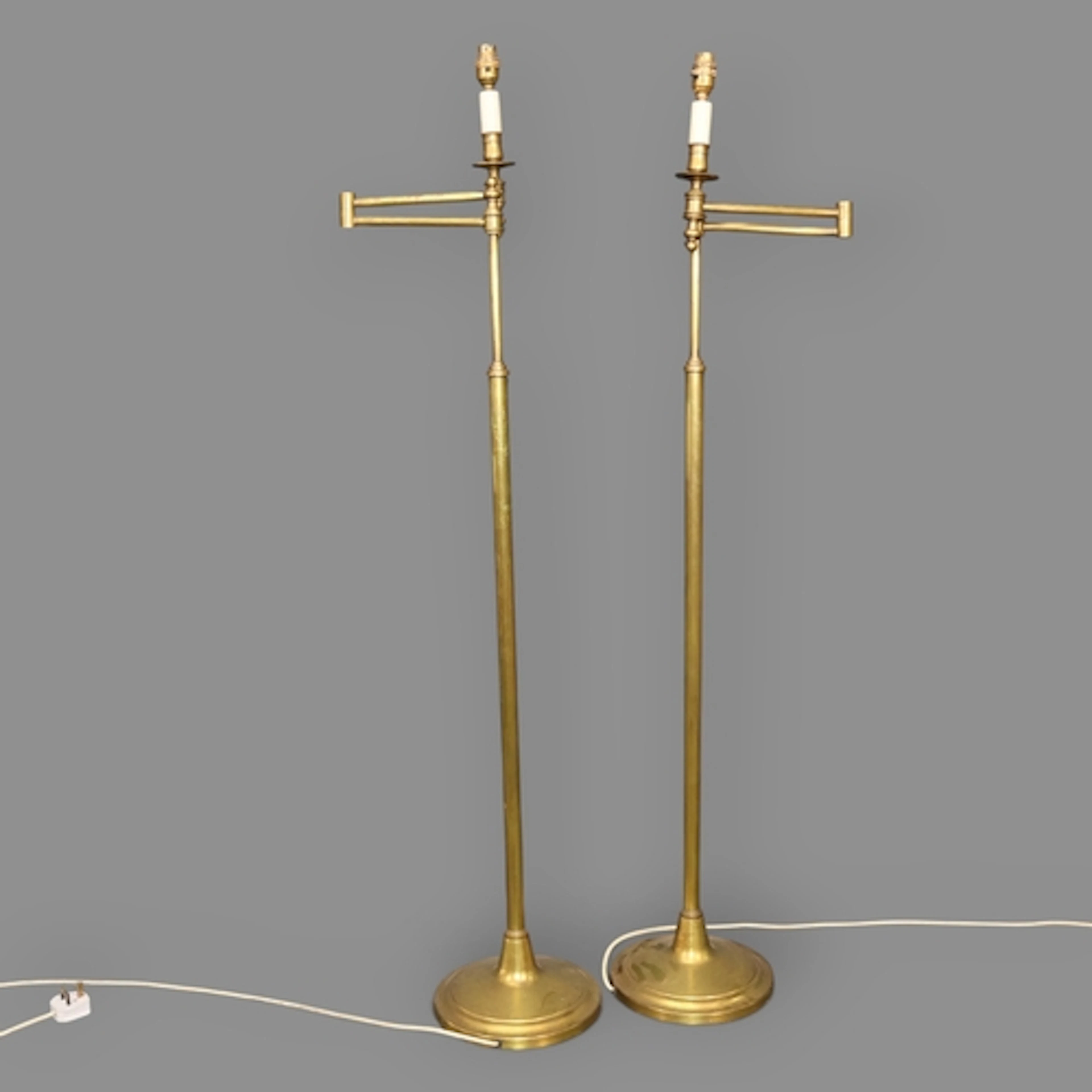 A pair of vintage brass swing-arm floor lamps. Height to bay...