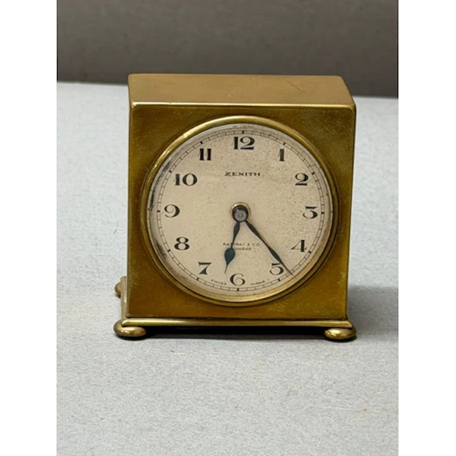 A Zenith travel alarm clock, retailed by Rattray & Co Du...