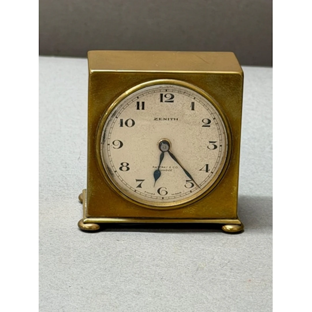 A Zenith travel alarm clock, retailed by Rattray & Co Du...