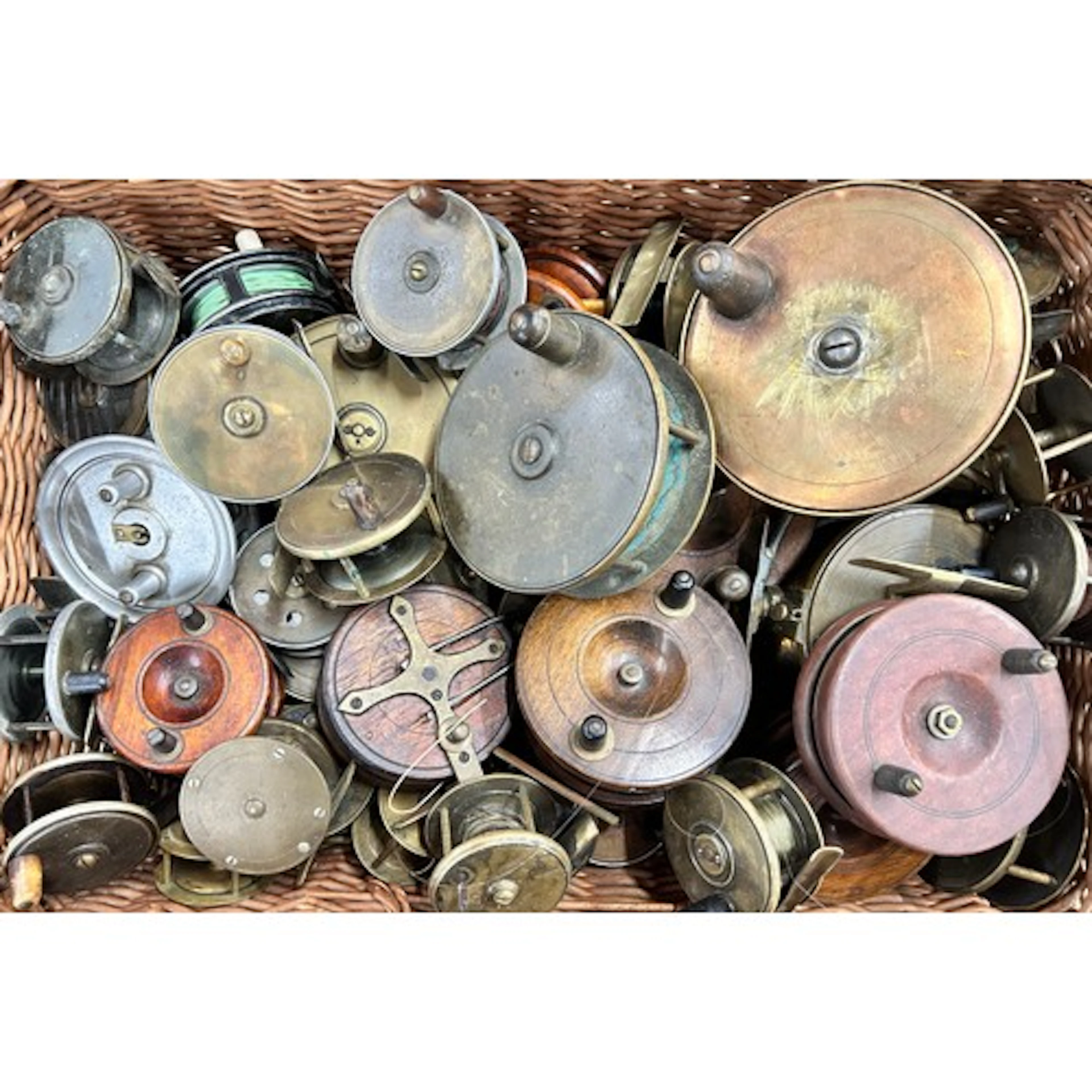A large collection of antique and vintage fishing reels, woo...