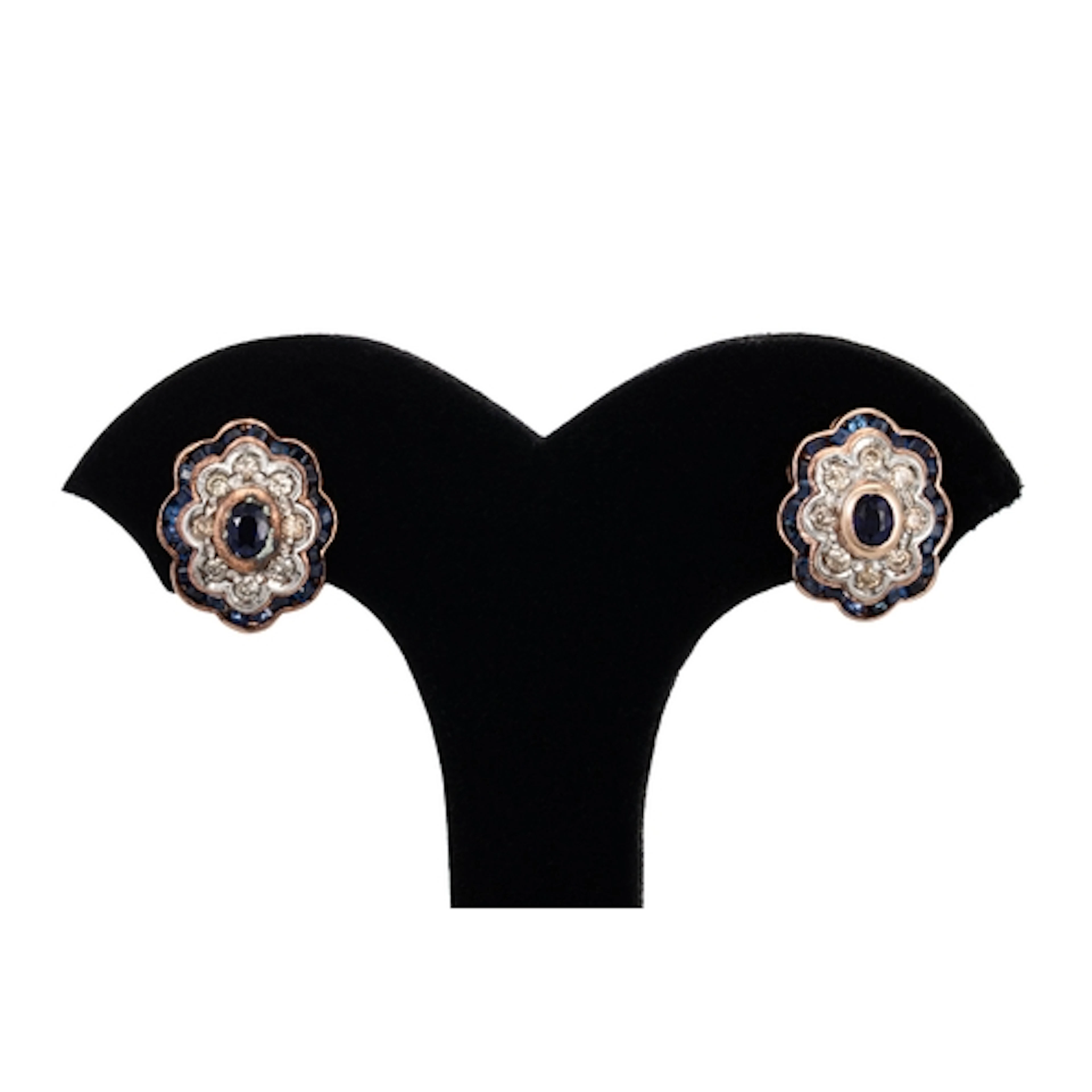 A PAIR OF SAPPHIRE AND DIAMOND CLUSTER EARRINGS, of wavy out...