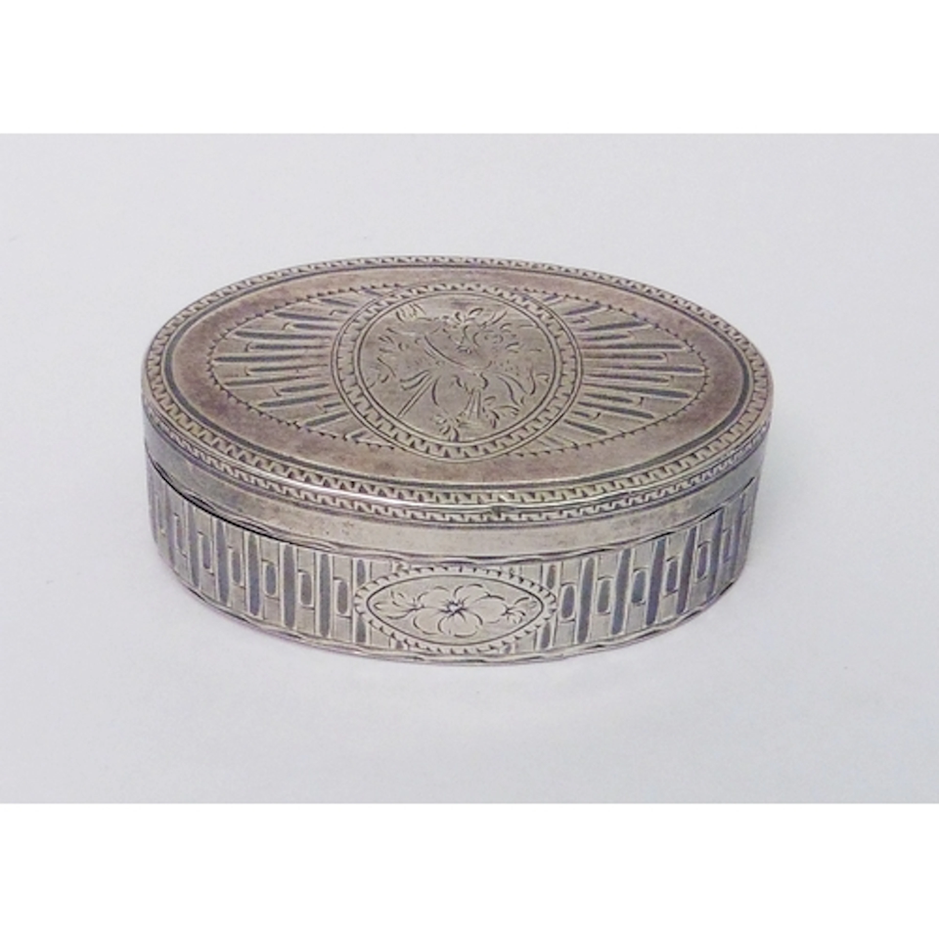 A French oval snuff box heavily engraved with star burst des...