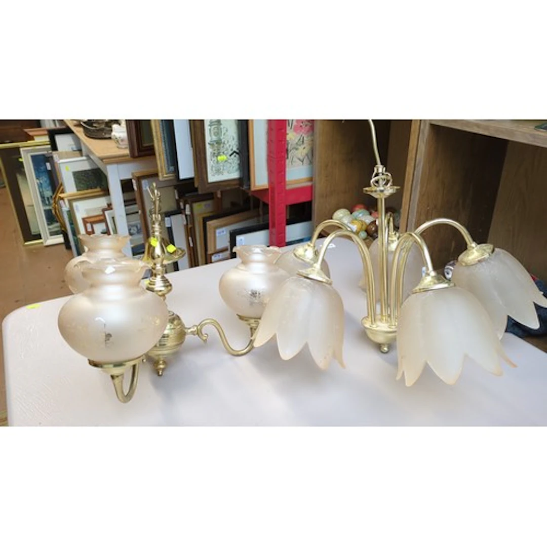 A pair of brass-finish multi-arm chandeliers: one with frost...