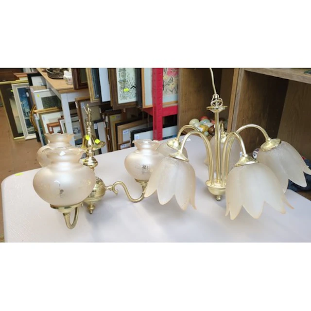 A pair of brass-finish multi-arm chandeliers: one with frost...