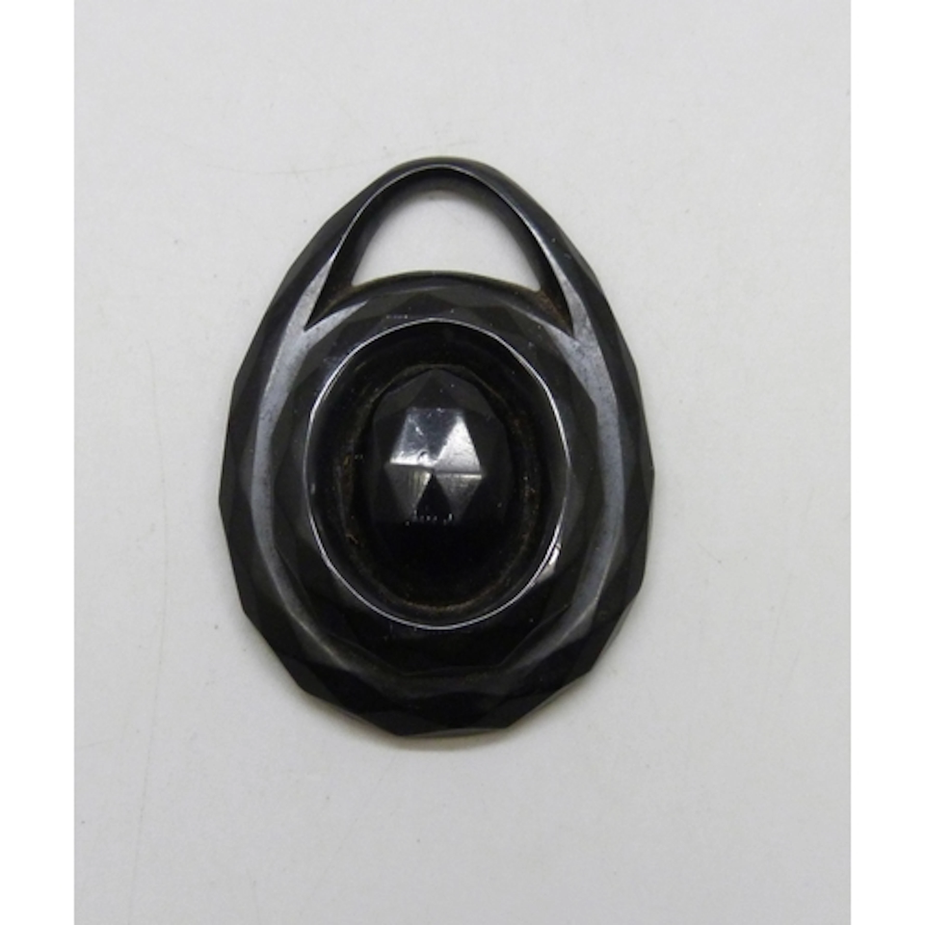 A Victorian carved jet pendant with hand painted porcelain p...