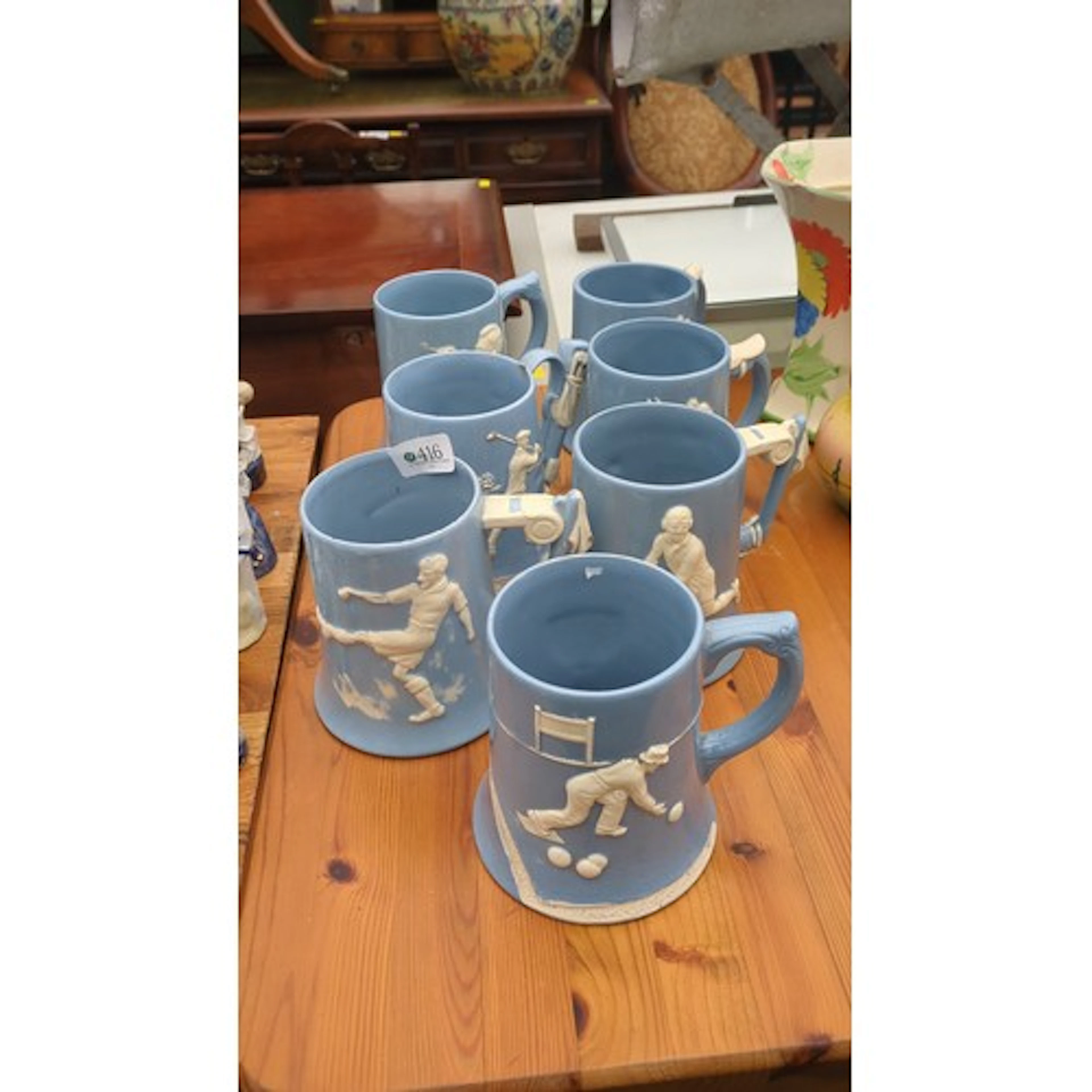 A group of Dartmouth Pottery blue jasperware tankards, each ...