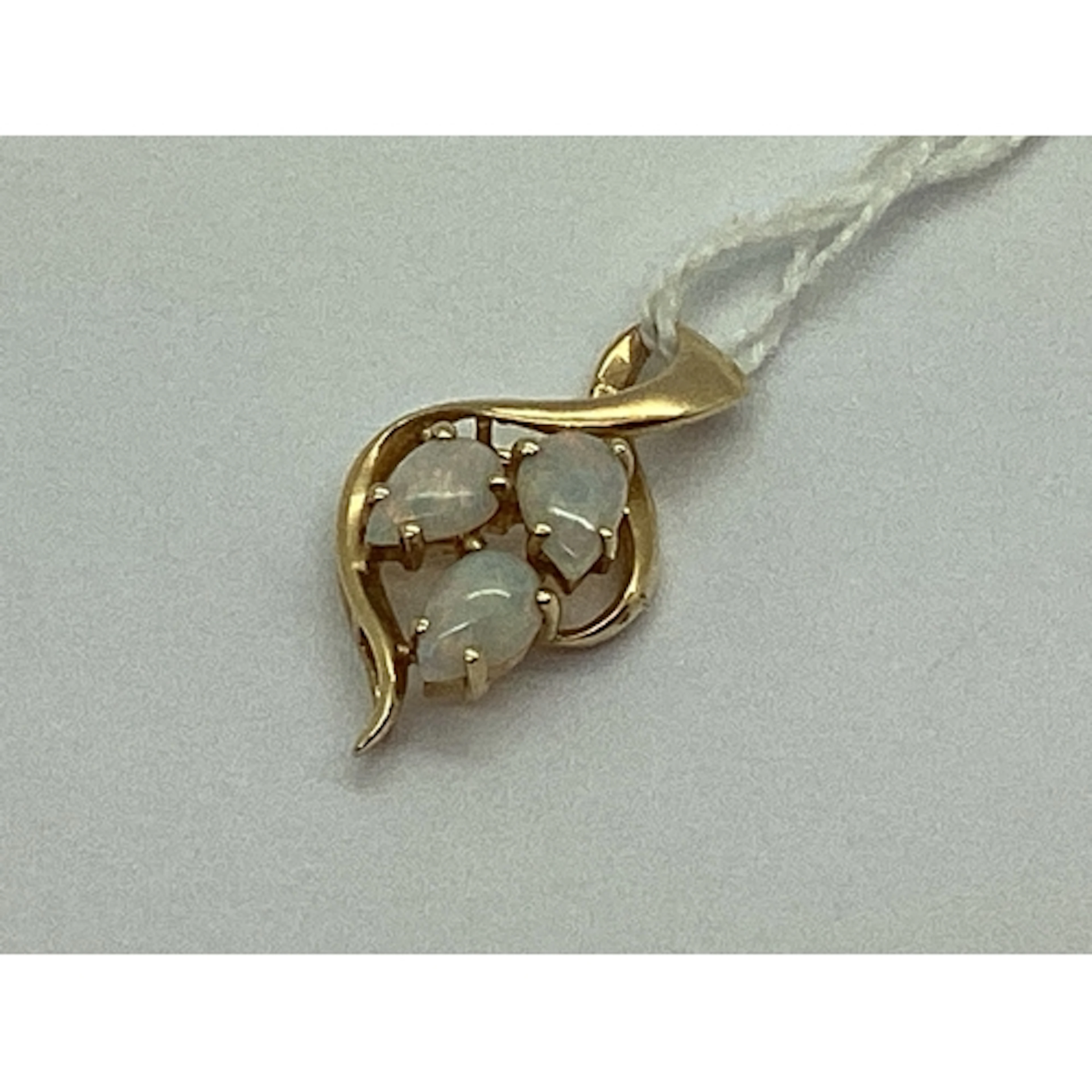 A Three Stone Opal Pendant, of abstract design, teardrop cab...