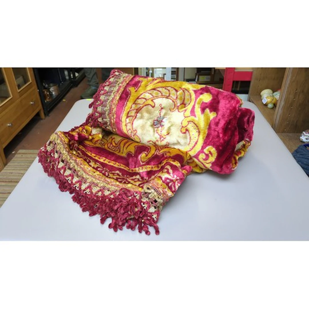 A set of velvet curtains with burgundy, gold and cream folia...