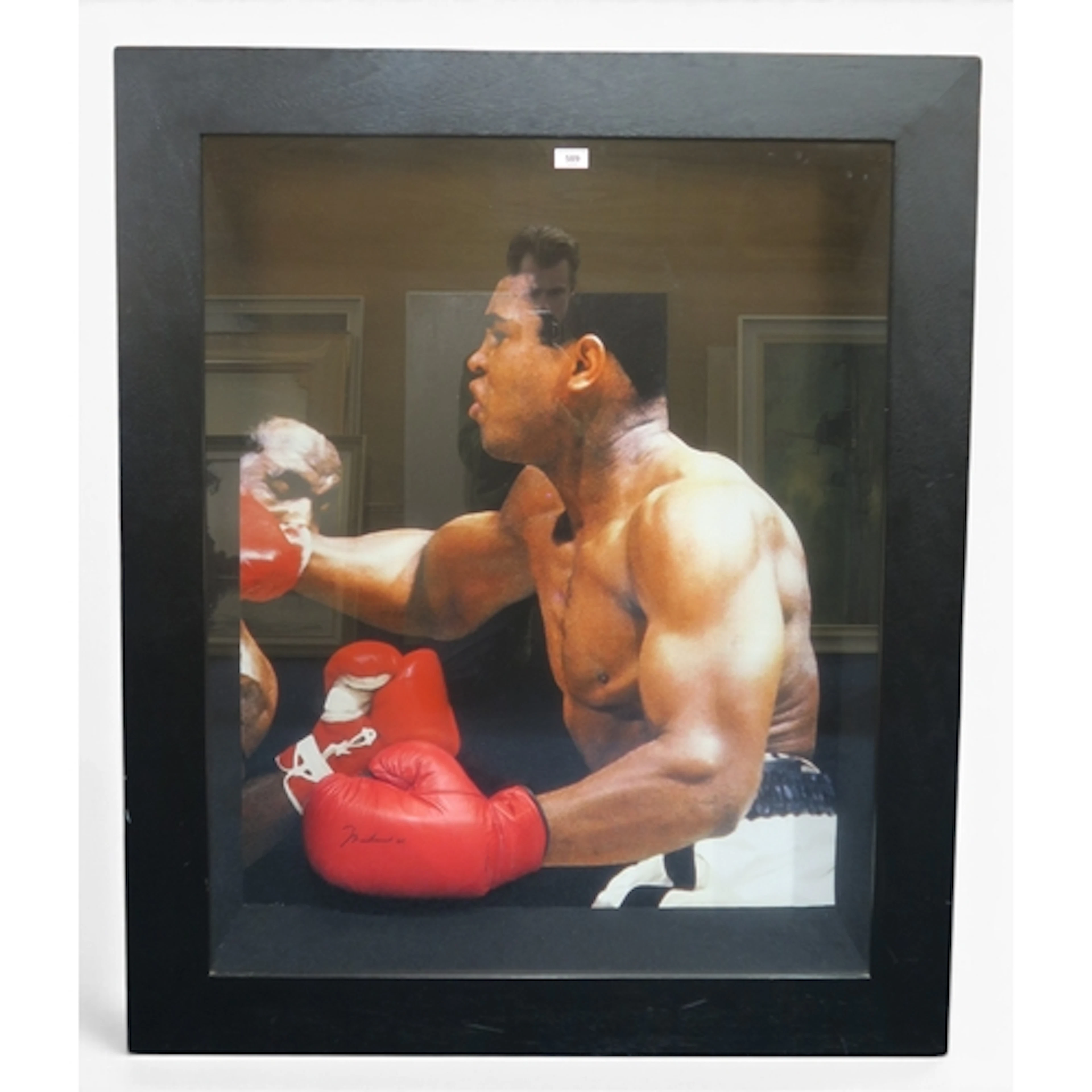 Muhammad Ali A signed boxng glove, presented on a life-size...