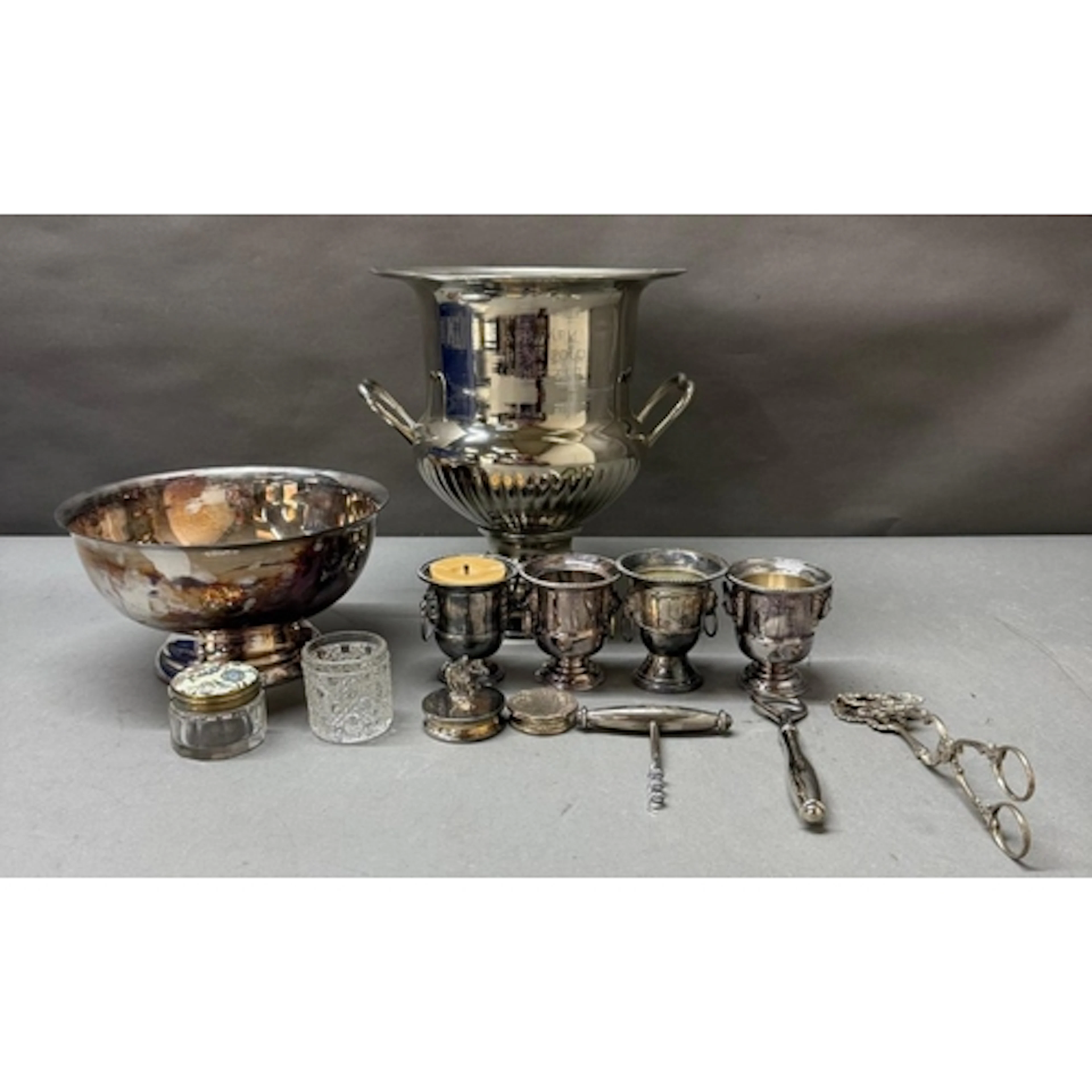 A selection of silverplated items to include a Champagne buc...