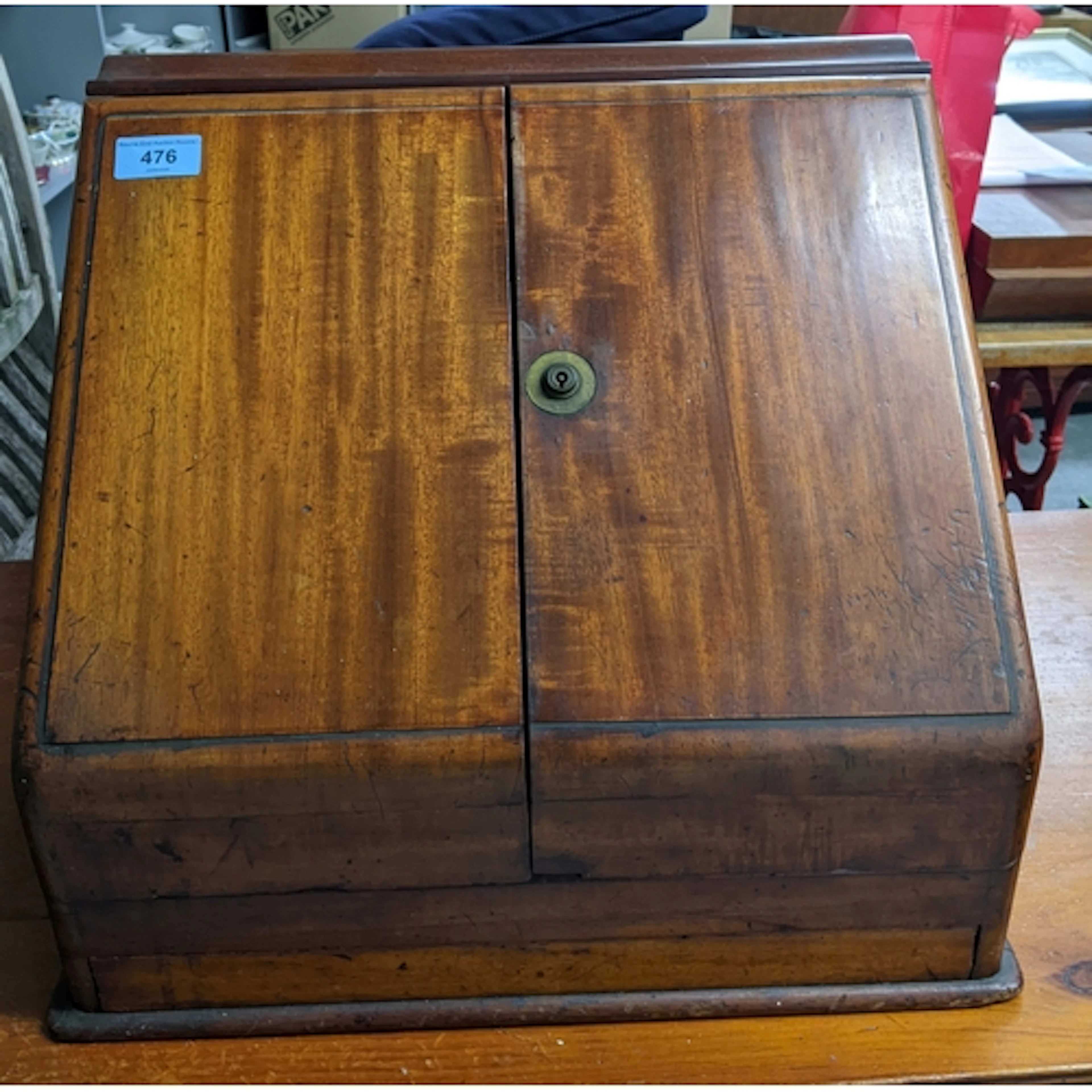 An early 20th century desk top stationery cabinet with twin ...