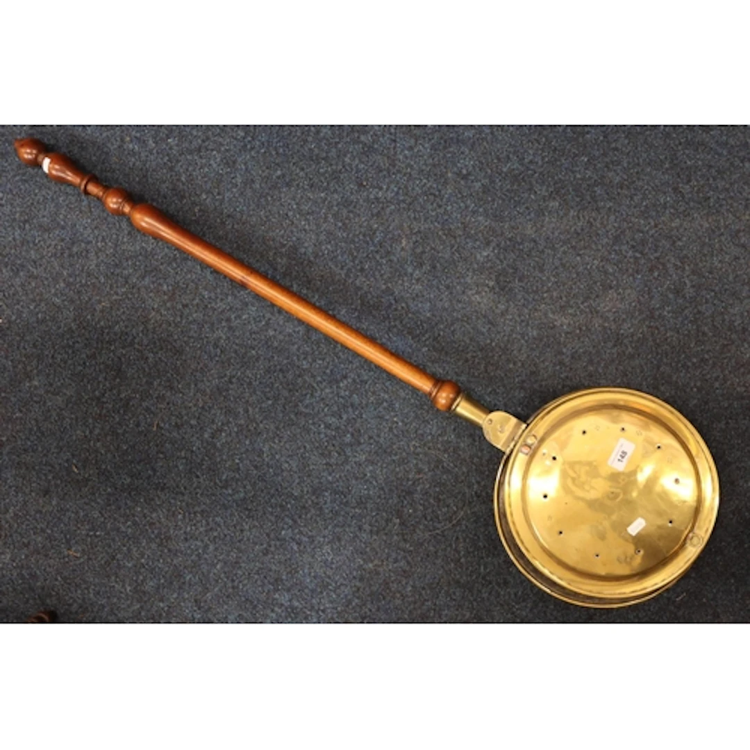 Brass bed warming pan of typical form.