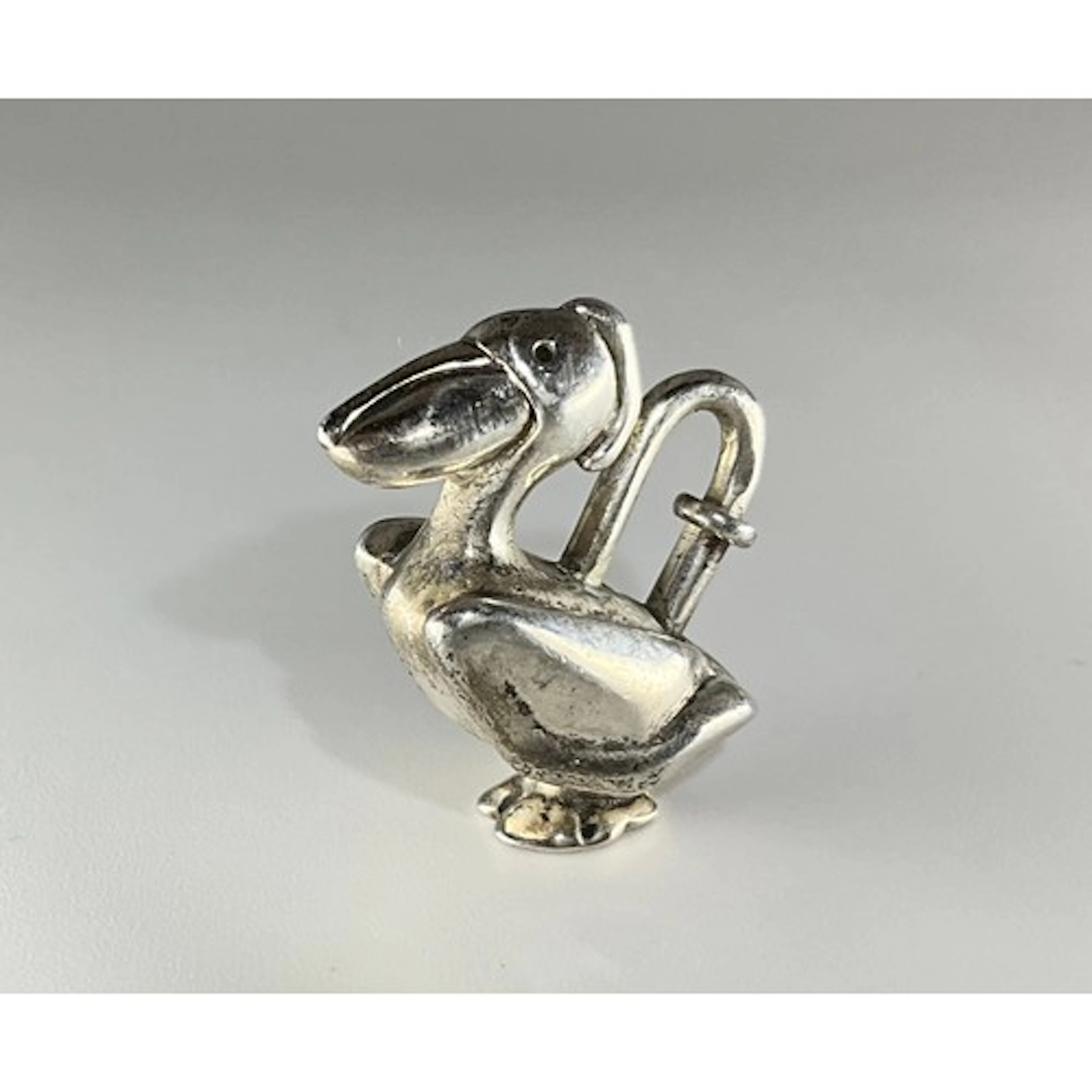Hermes - a silver bag charm, as a Pelican, spring clasp, st...