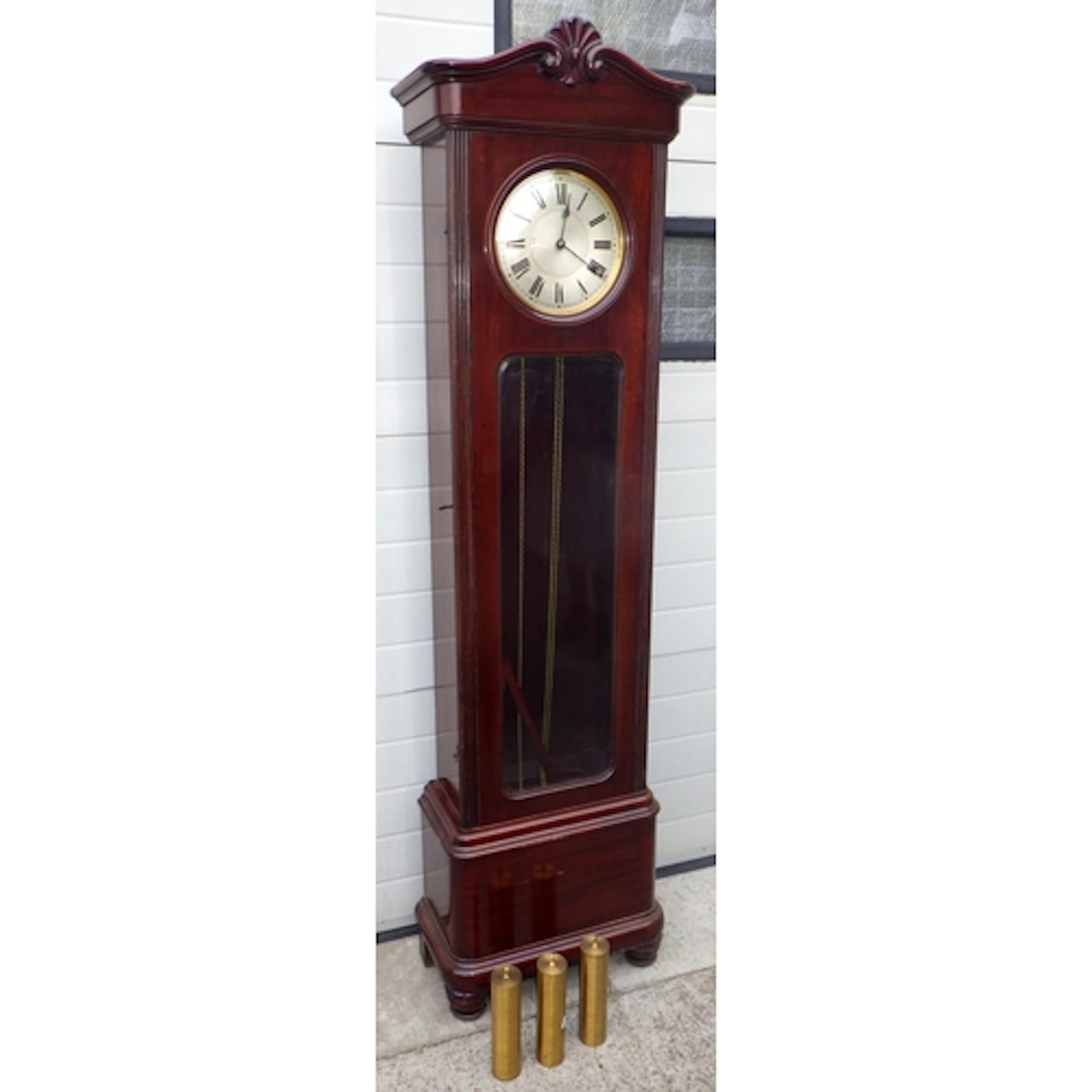 An Edwardian mahogany three weight longcase clock with bevel...
