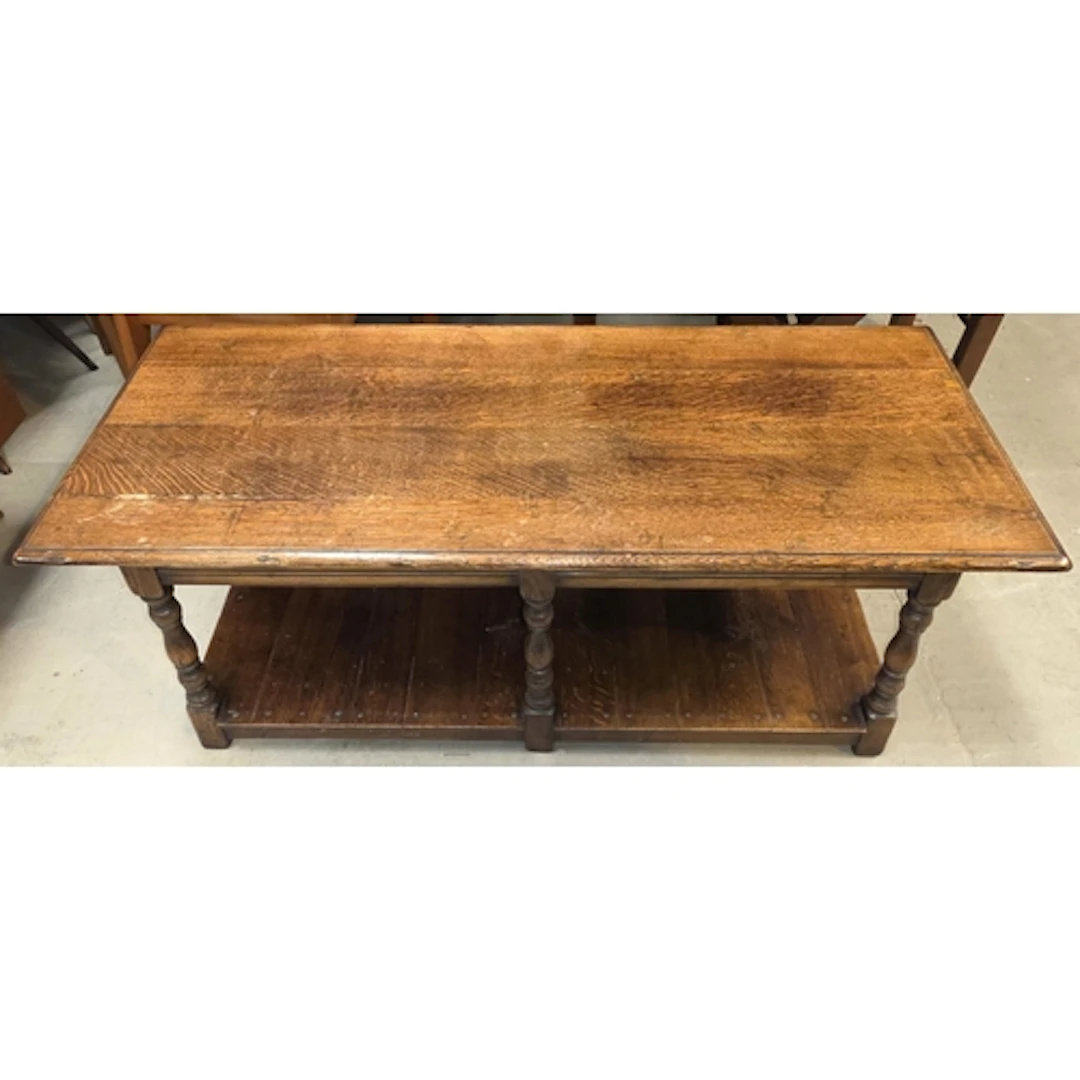 A solid oak country 2 tier coffee table in the manner of Tit...