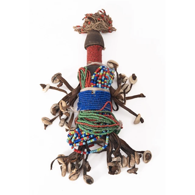 A 20th Century fertility doll with beads and shells and a Br...