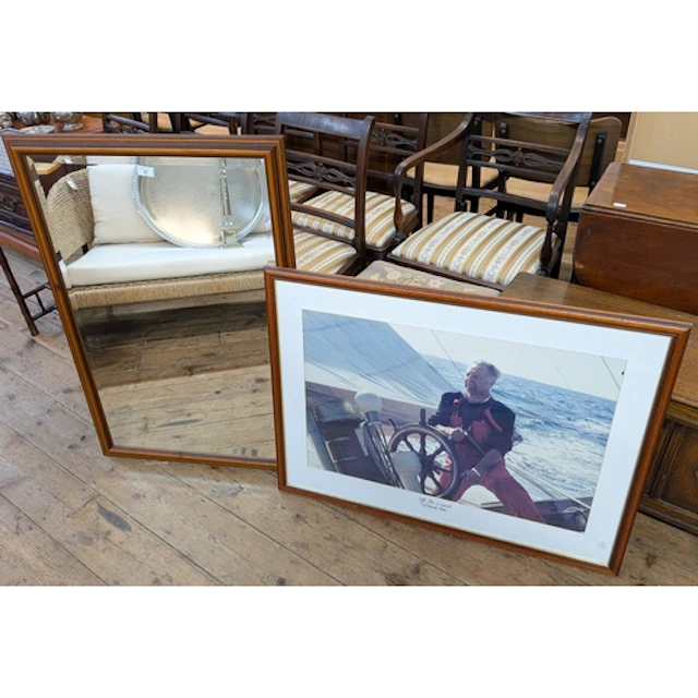 A large wall mirror in mahogany frame and a framed photograp...