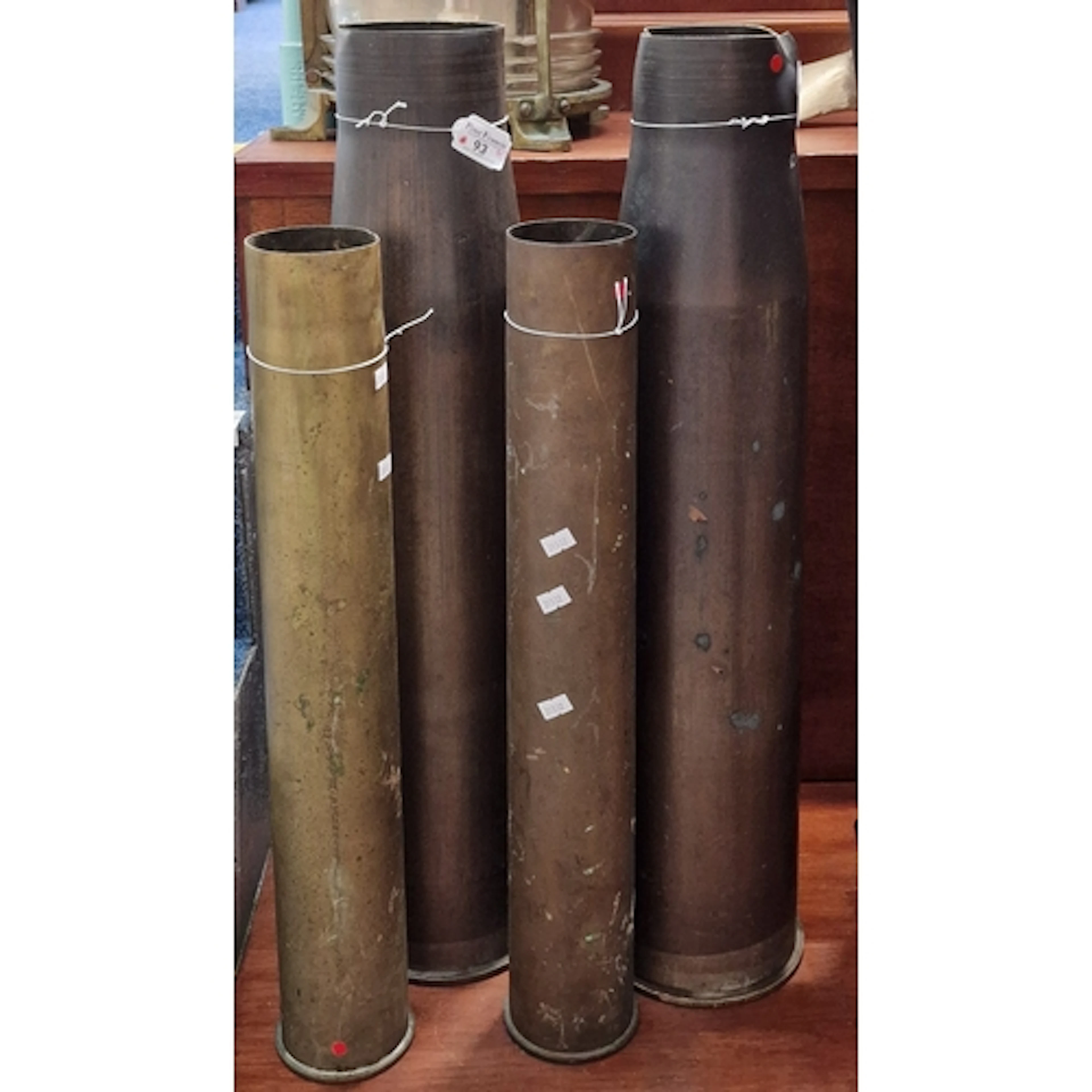 Collection of four large brass shell cases, comprising two B...