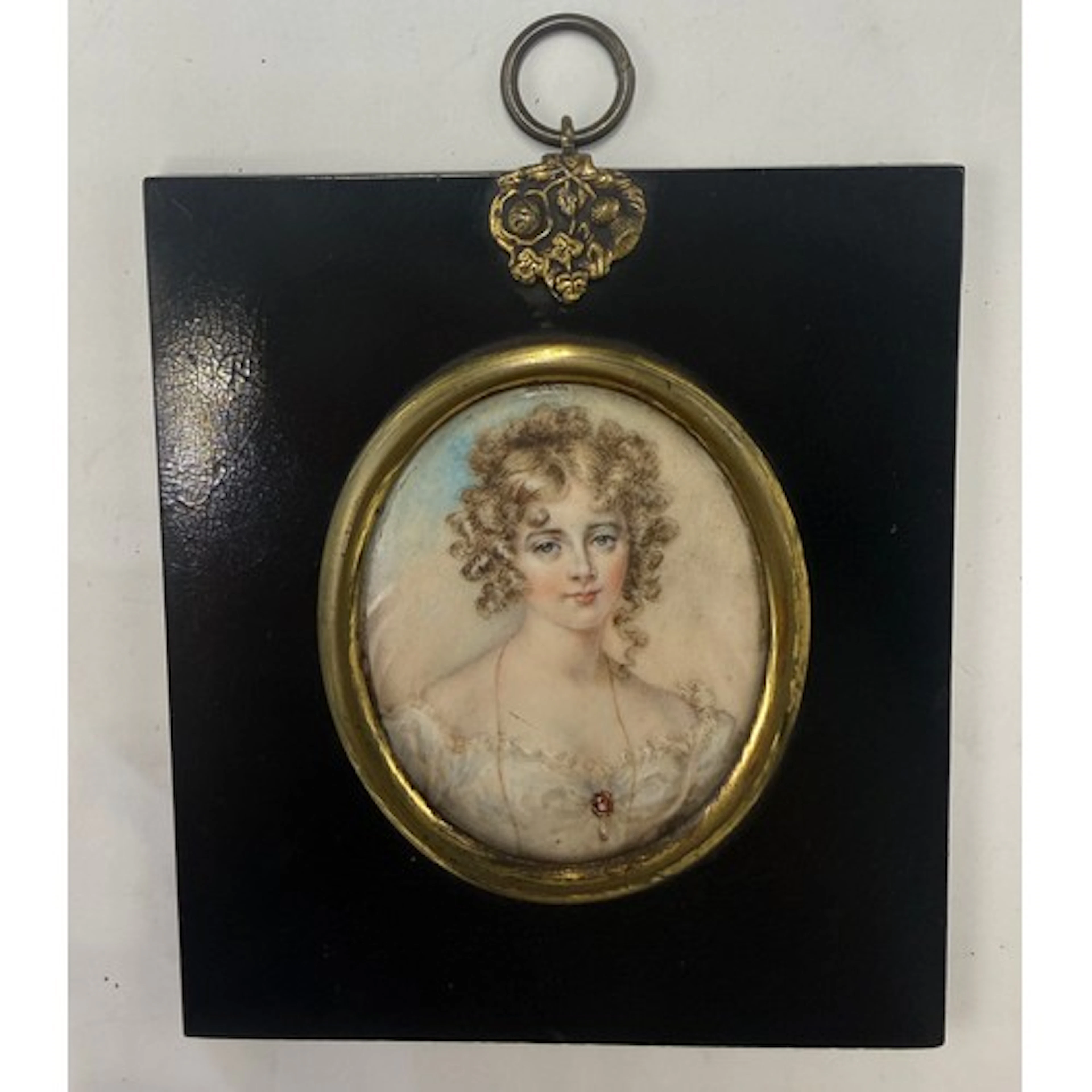 A portrait miniature painting on ivory depicting a girl in a...