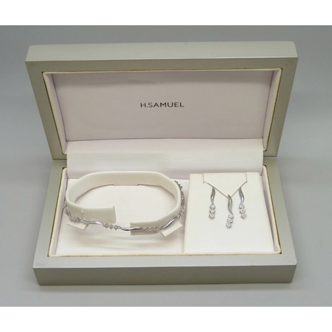 A 9ct white gold and diamond bracelet, earring and necklace ...