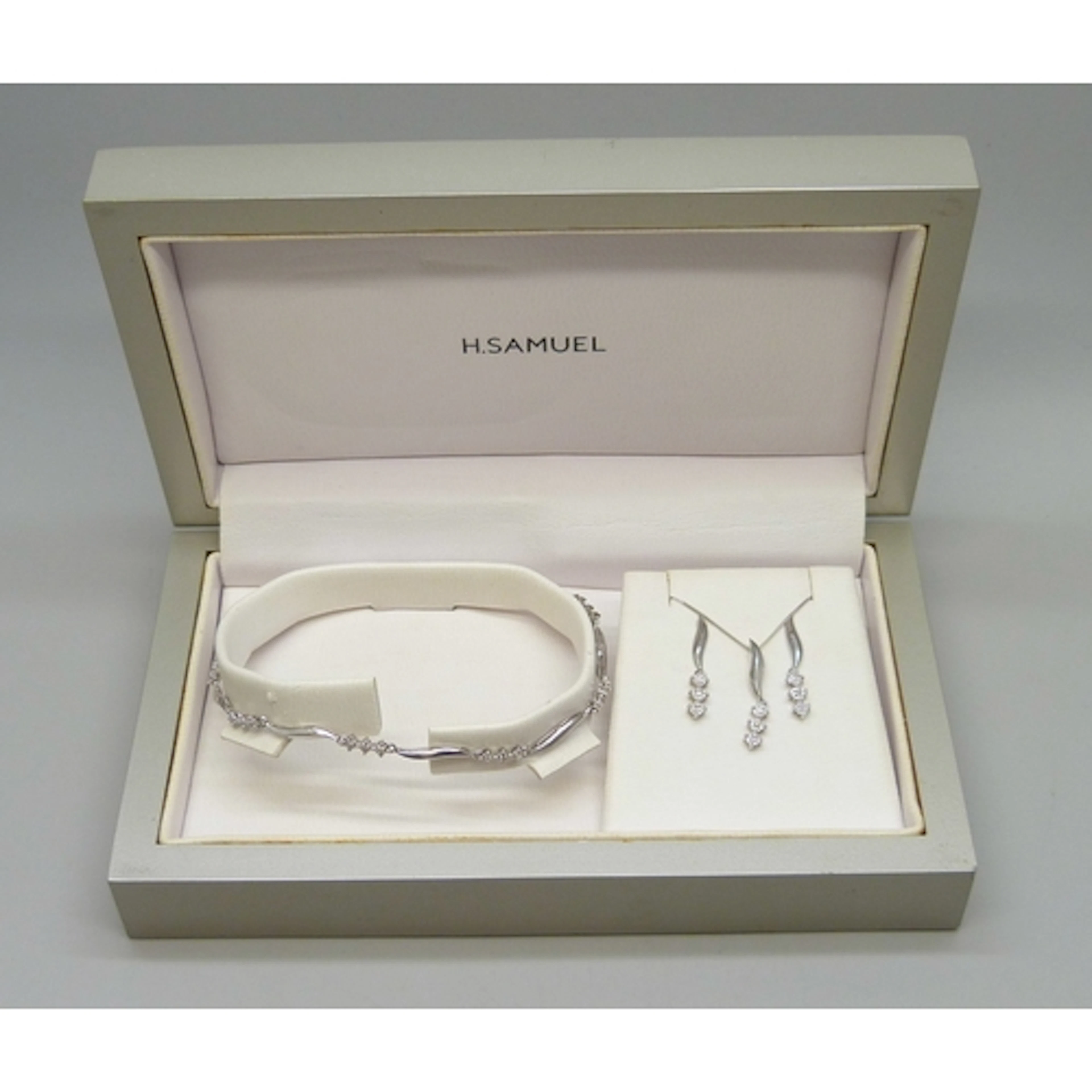 A 9ct white gold and diamond bracelet, earring and necklace ...