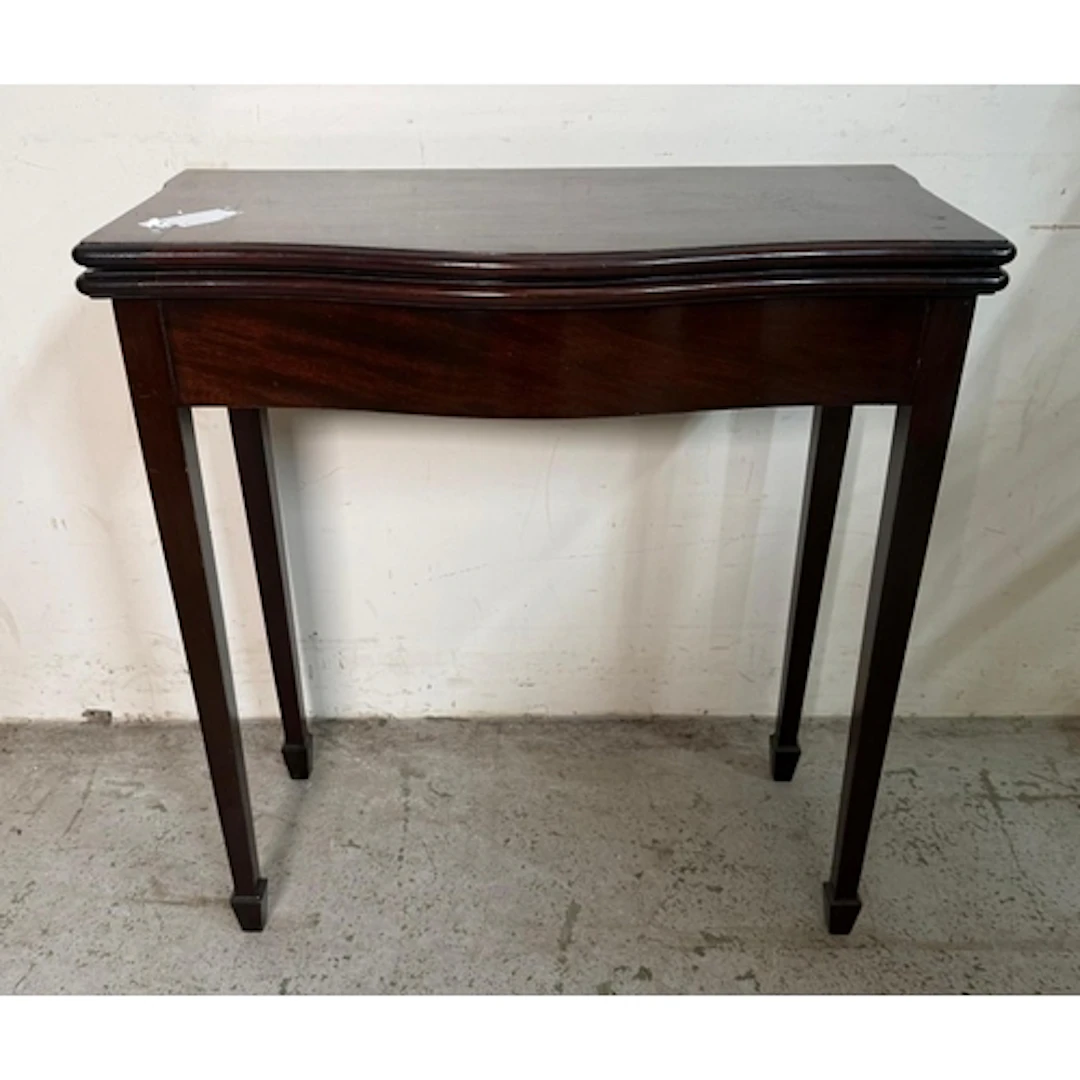 A fold over games table on tapering legs.