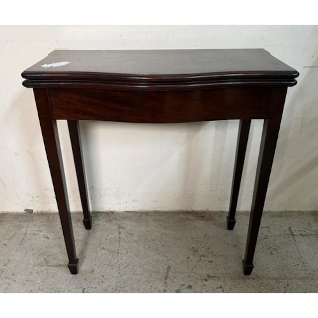 A fold over games table on tapering legs.