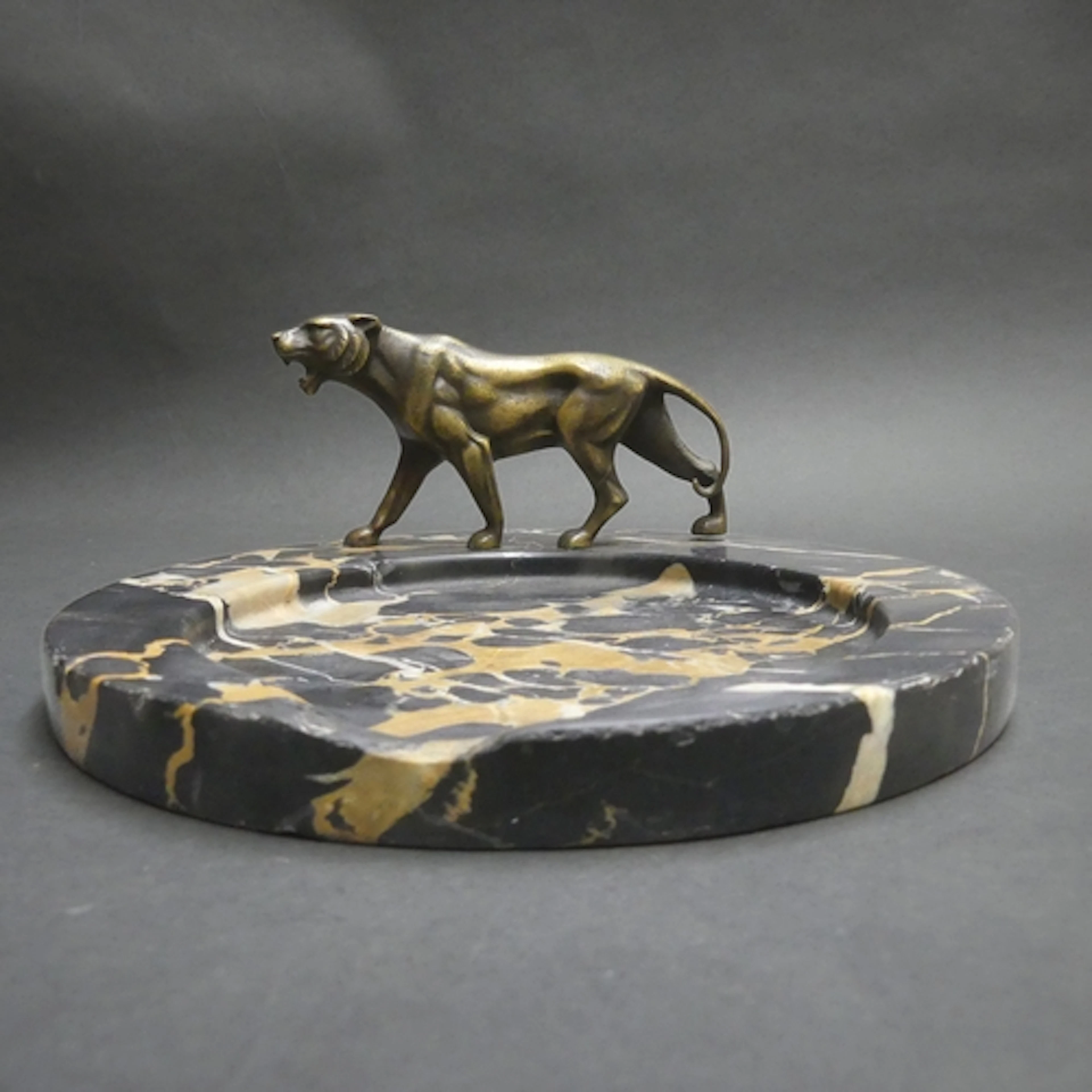 An Art Deco black marble circular desk tray, with cast bronz...