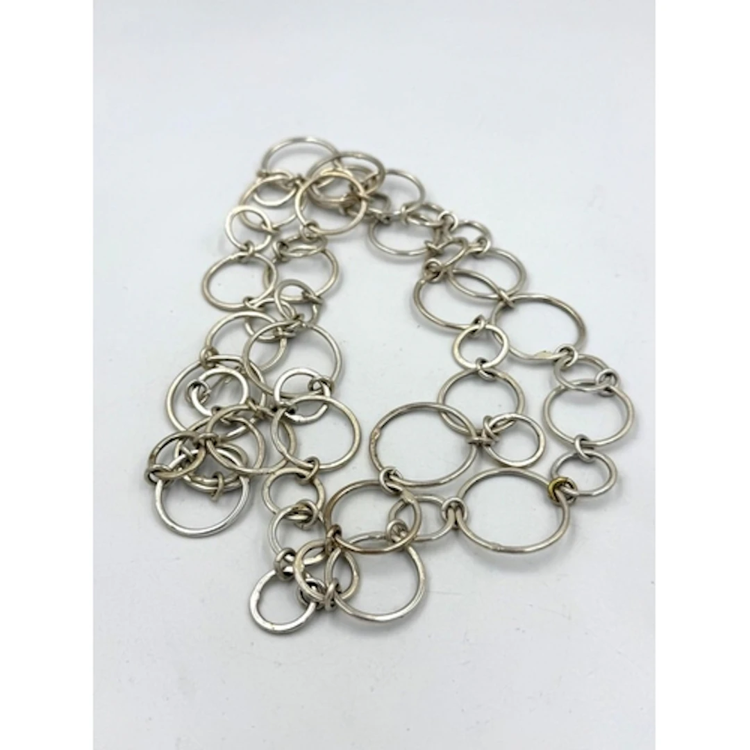 A silver circle themed belt or necklace