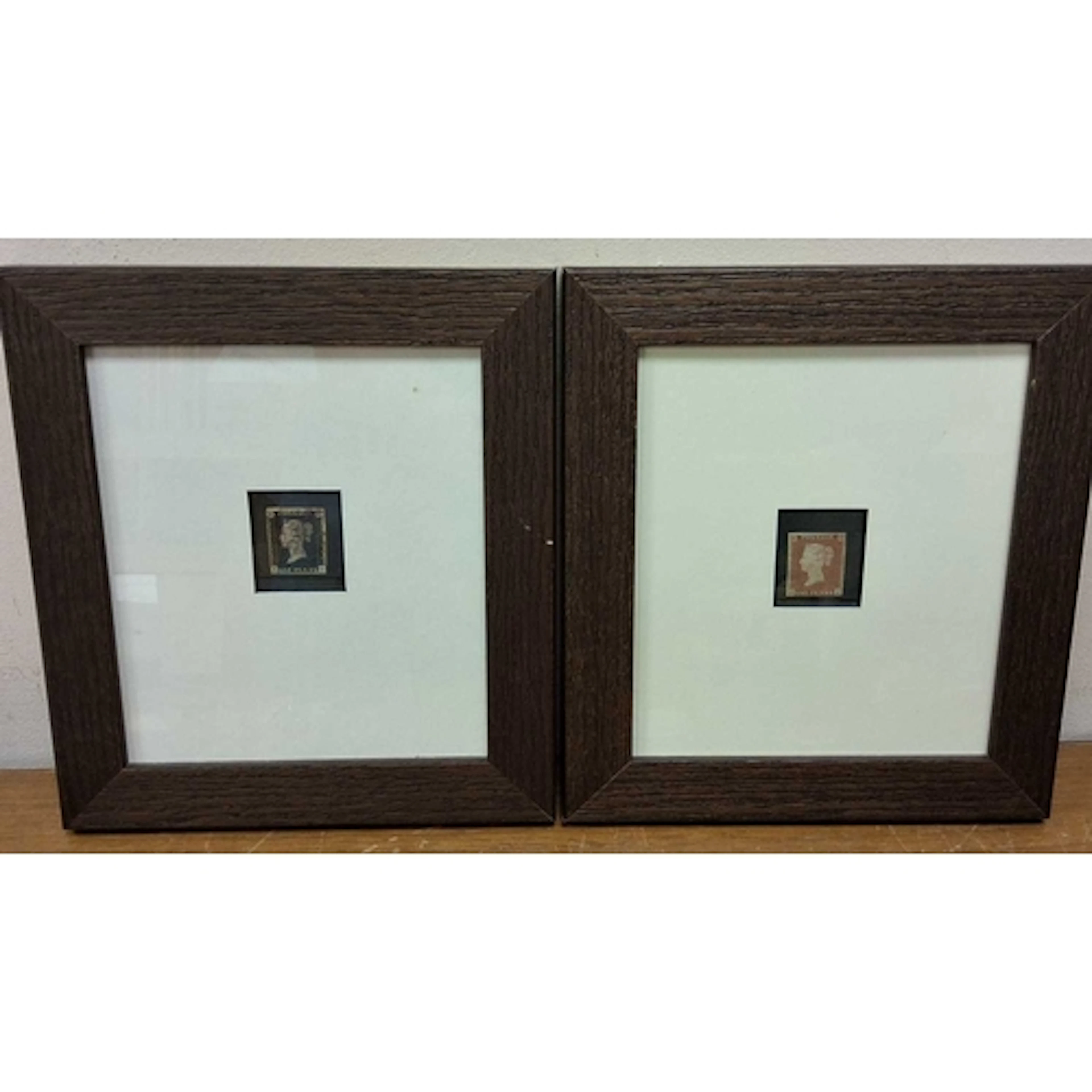TWO MOUNTED AND FRAMED POSTAGE STAMPS, comprising a Great Br...