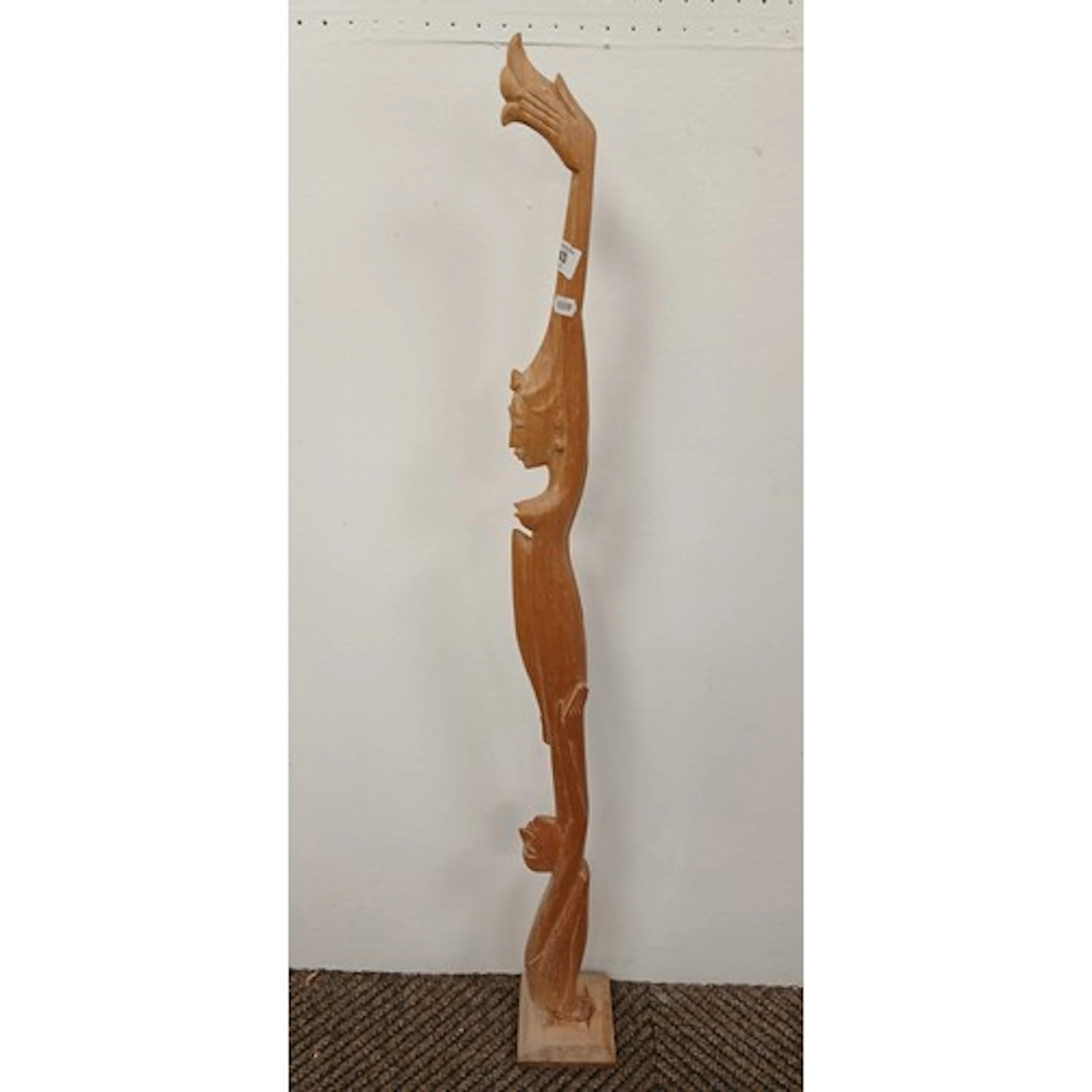 Carved tribal ceremonial staff decorated with carved figures...