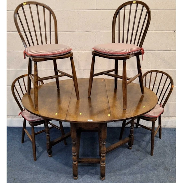 A GOOD QUALITY REPRODUCTION OAK GATE LEG TABLE, raised on bl...