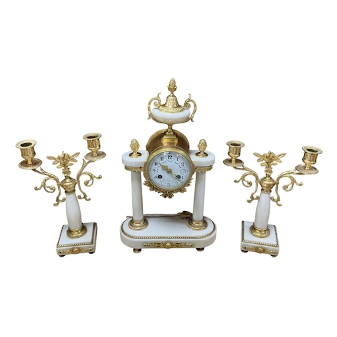 A gilt metal and marble Portico clock garniture with floral ...