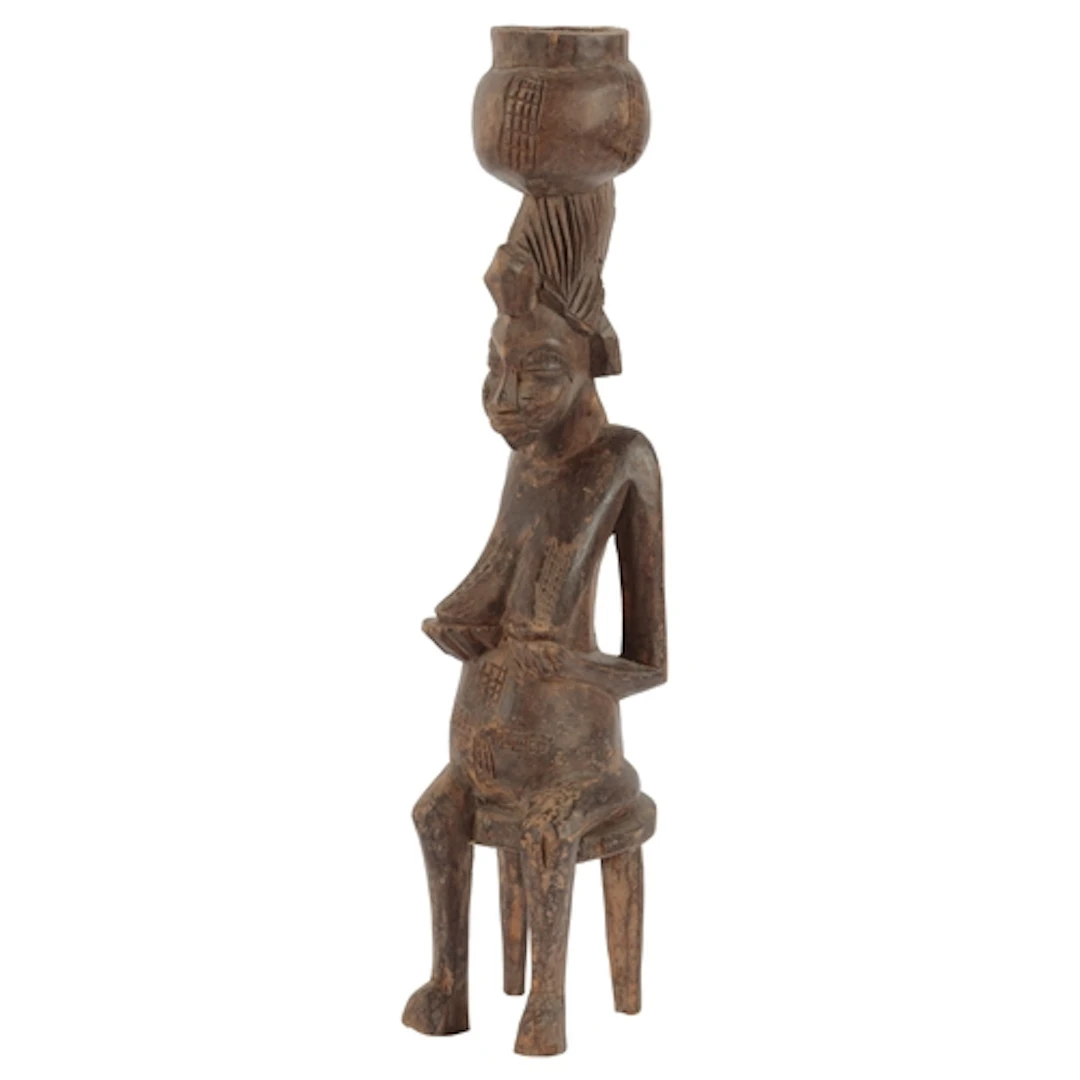 A Senufo fertility figure, Ivory Coast, modelled as a woman ...
