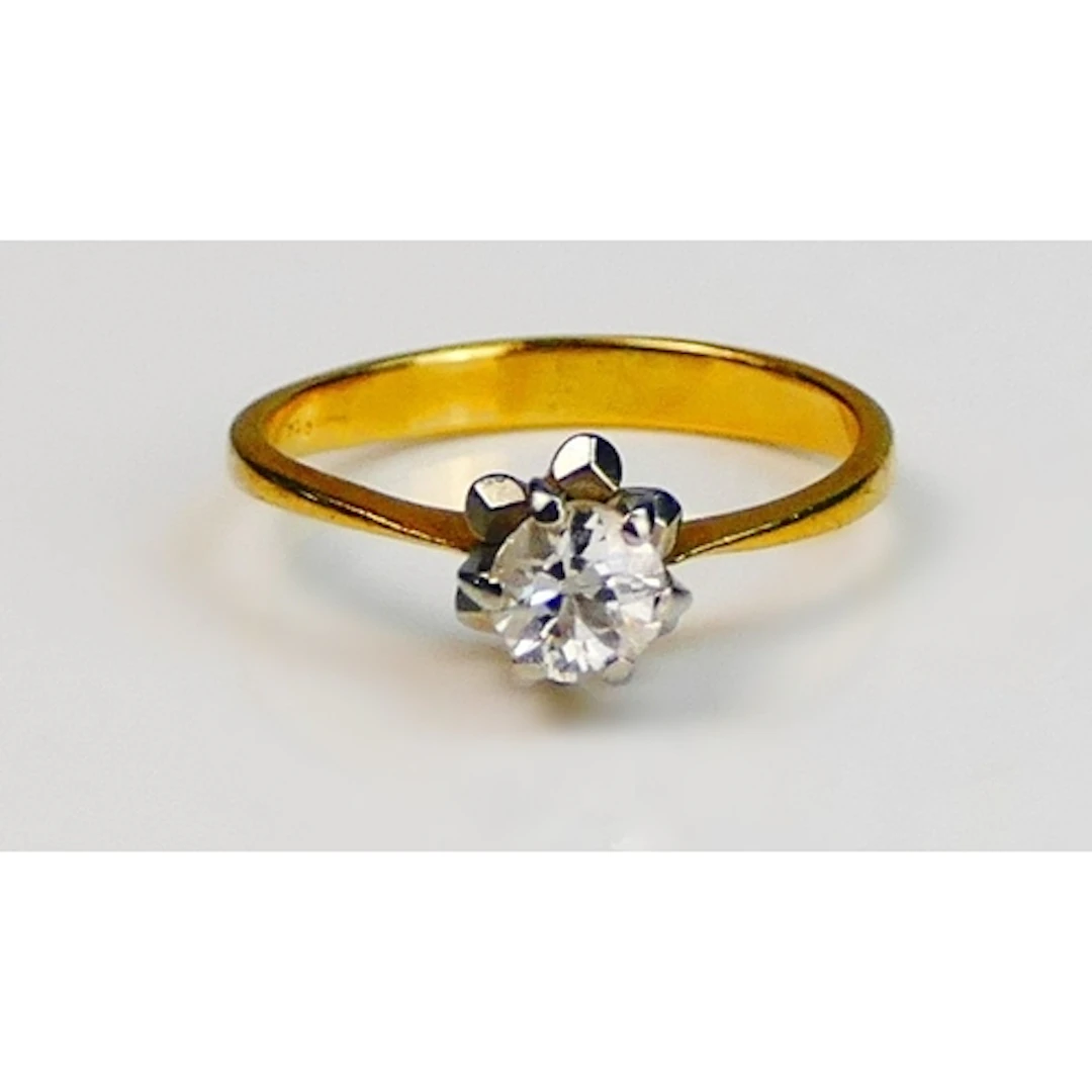 A brilliant round cut diamond solitaire engagement ring in a...