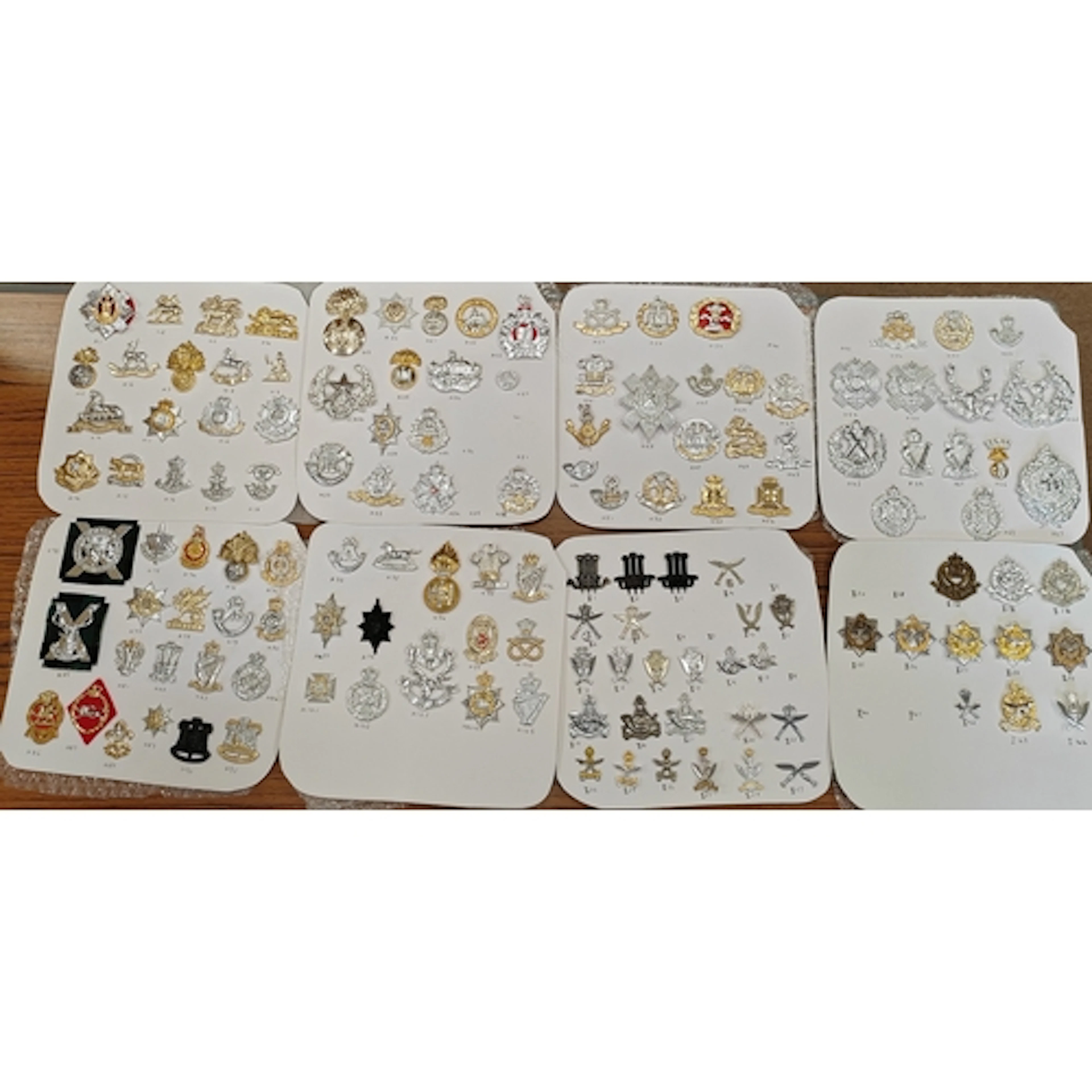 Collection of cap badges from various regiments including Gu...
