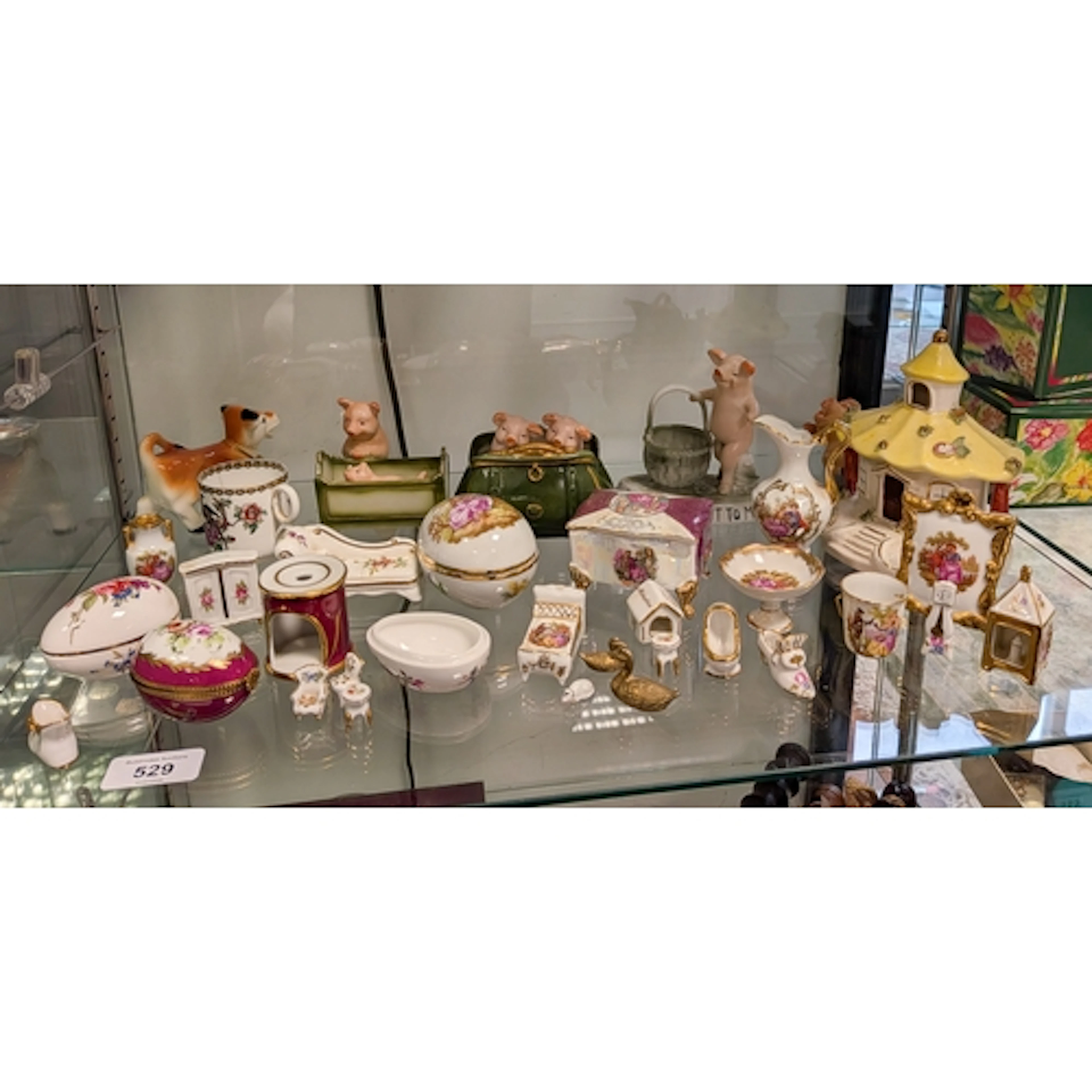 A collection of pig fairings, miniature Limoges china and a ...