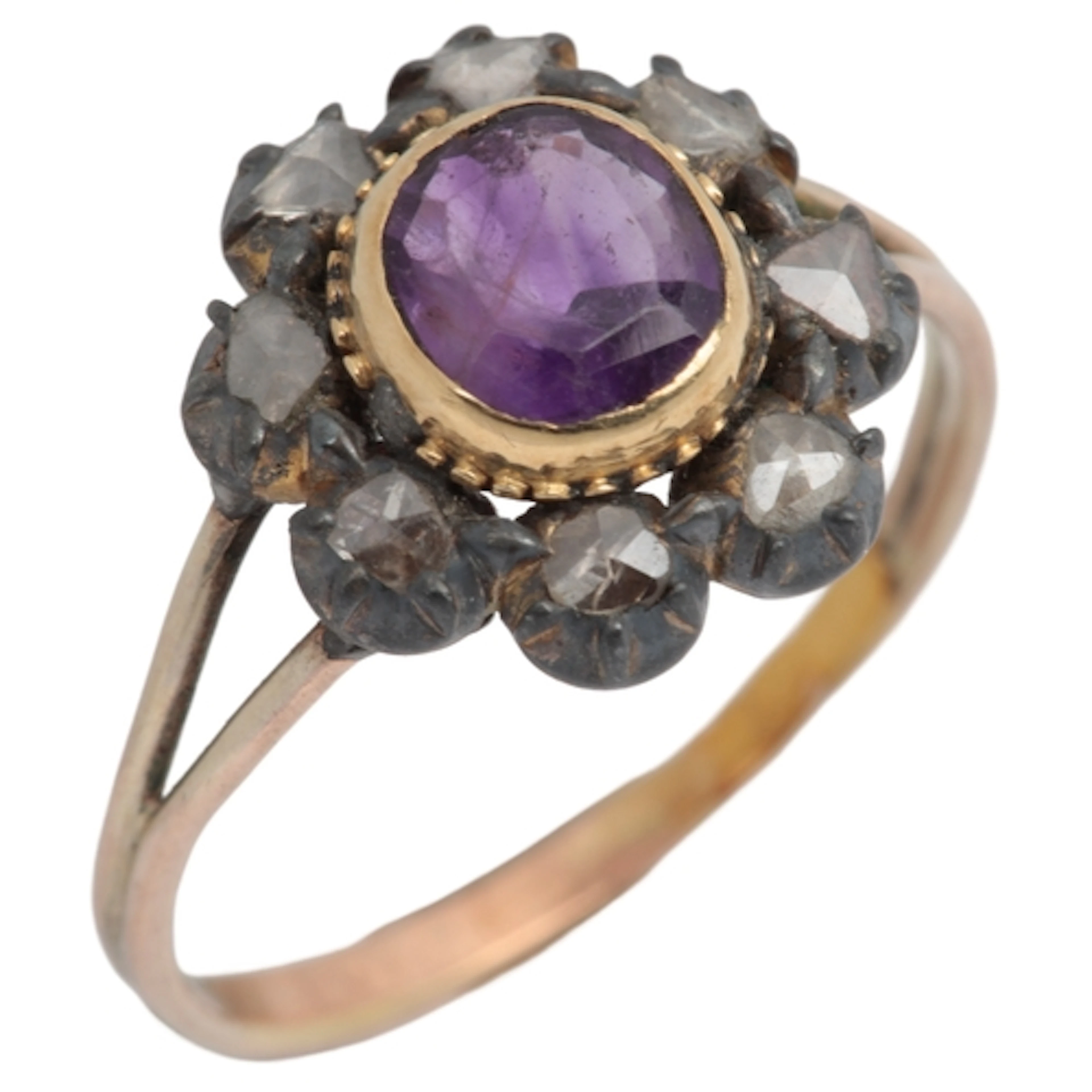 An amethyst and diamond cluster ring, centring on an oval am...