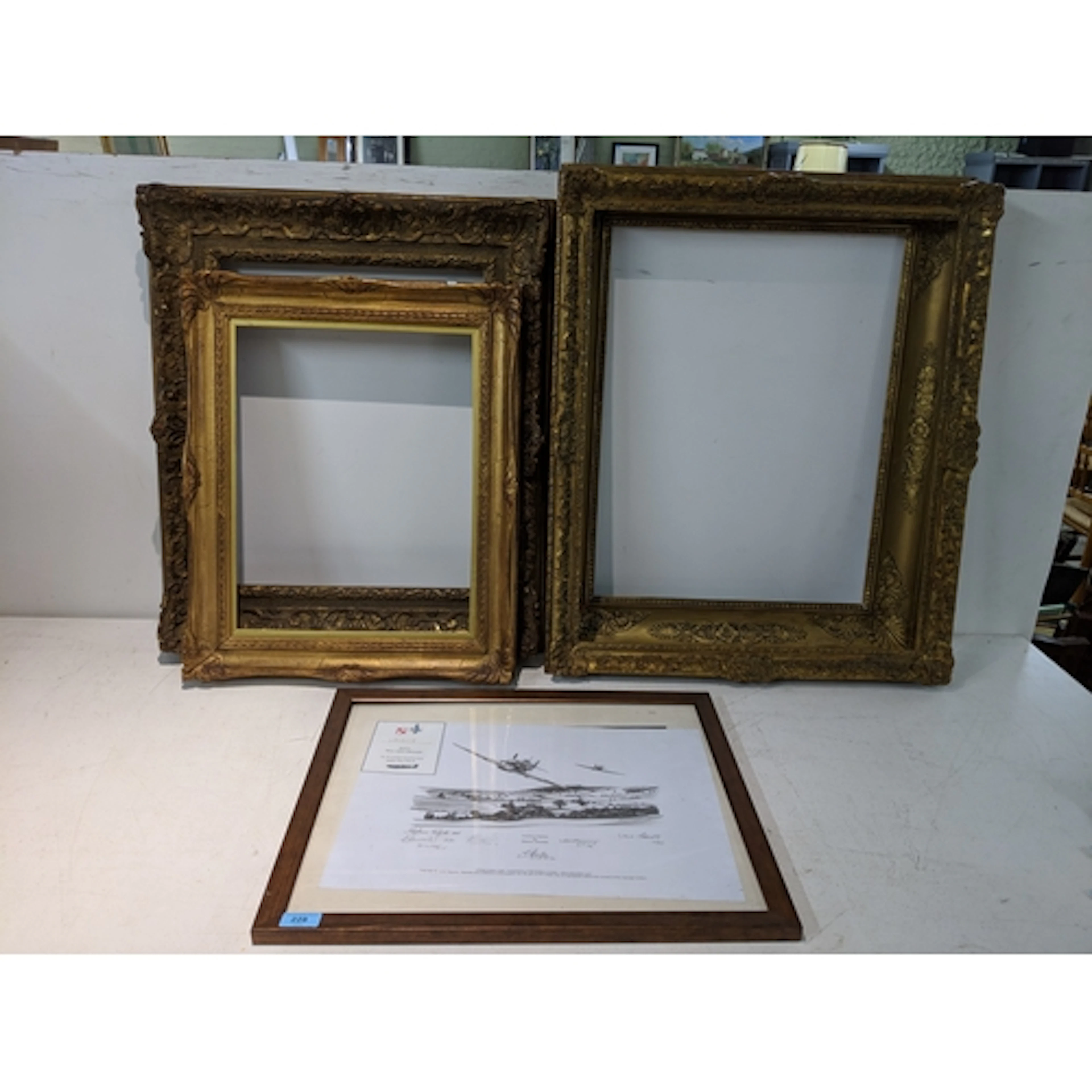 Four gilt frames and a print depicting two Spitfires flying ...