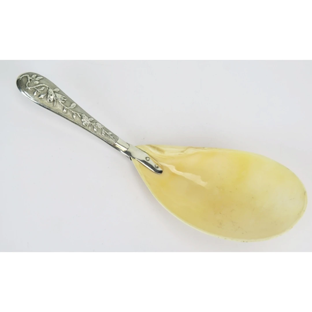 A Chinese silver handled ladle with shell bowl and low relie...